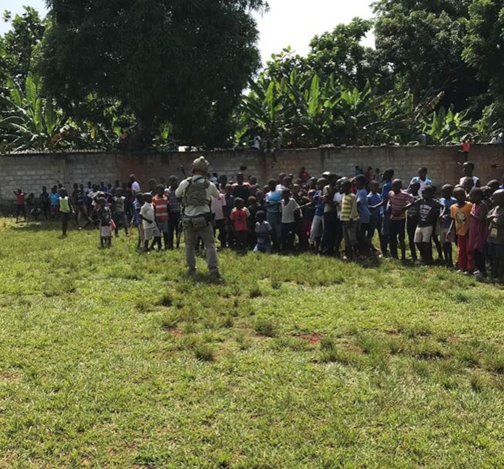 A Special Tactics operator greets Haitian citizens as he secures the area for a delivery of humanitarian aid supplies as part of Joint Task Force-Haiti. Special Tactics Airmen responded to a request to augment relief efforts in Haiti after a 7.2 magnitude earthquake hit the country Aug. 14, 2021.