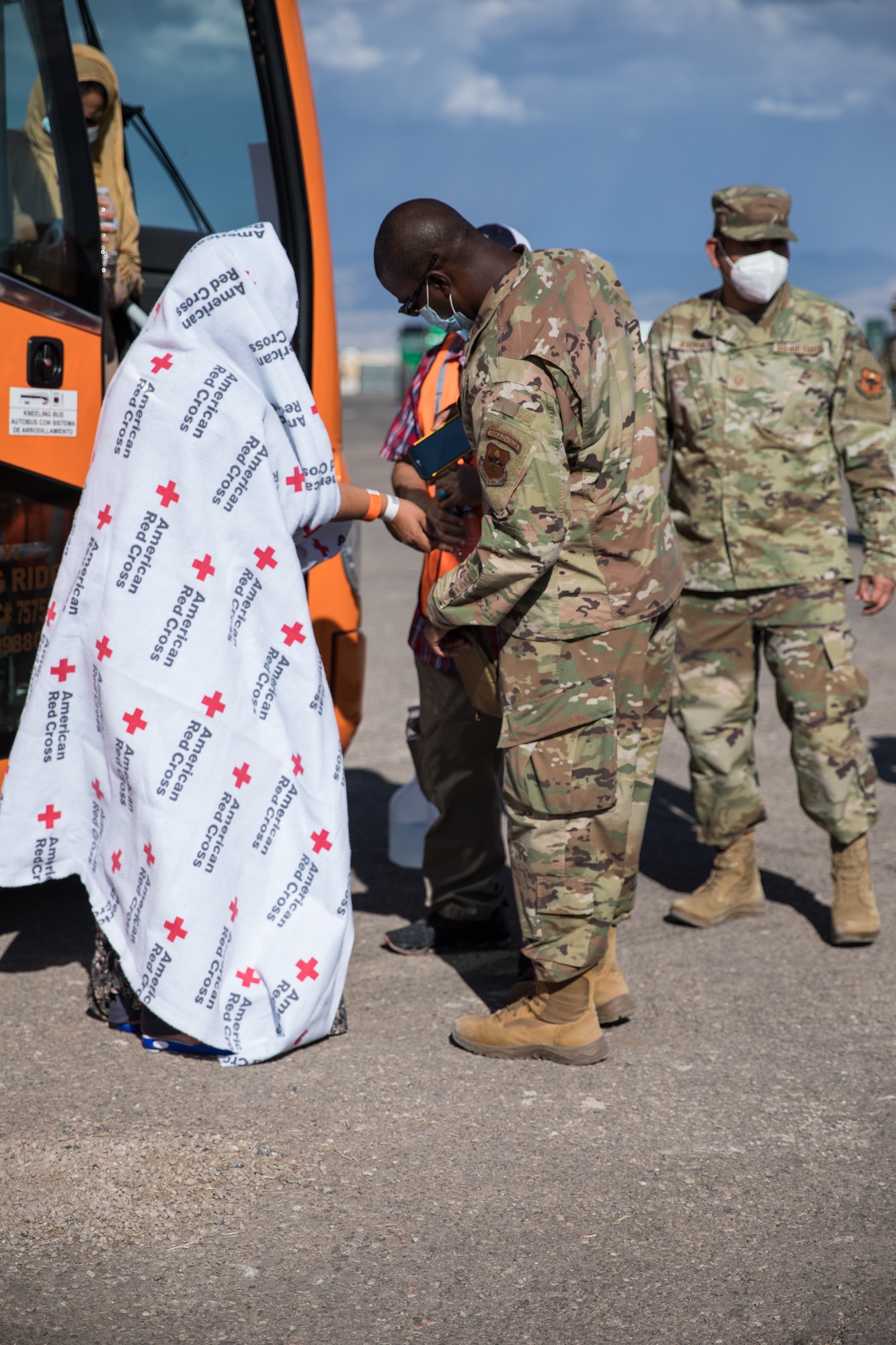 Airmen attached to Task Force-Holloman assists an Afghan personnel off the bus on Aug. 31, 2021, on Holloman Air Force Base, New Mexico. The Department of Defense, in support of the Department of State, is providing transportation and temporary housing in support of Operation Allies Welcome. This initiative follows through on America’s commitment to Afghan citizens who have helped the United States, and provides them essential support at secure locations outside Afghanistan. (U.S. Army photo by Pfc. Anthony X. Sanchez)