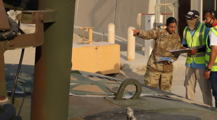 Army Reserve Warrant Officer Elaine Vargas, Army Field Support Battalion-Southwest Asia, 401st Army Field Support Brigade, reviews paperwork before allowing Humvee belonging to Delta Company, 1st Battalion, 504th Infantry Regiment, 82nd Airborne Division, to leave a yard at Camp Arifjan, Kuwait, Sept. 1, 2021. Vargas, the battalion's accountability officer, oversaw the flow of equipment and gear in and out of a lot from units that deployed to Operation Allies Refuge at Kabul's Hamid Karzai International Airport in support of evacuation operations as the U.S. military ended operations in Afghanistan.