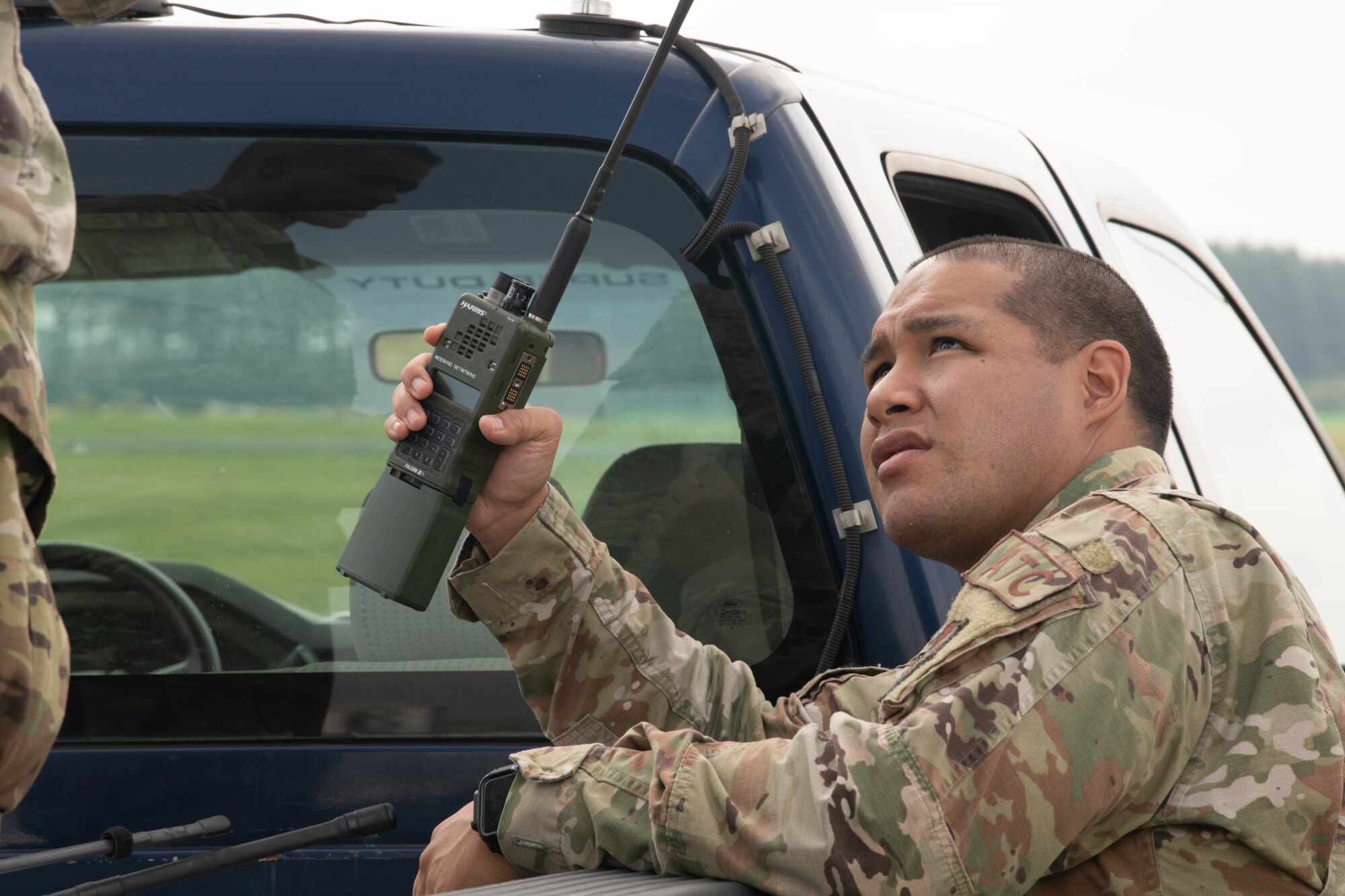 Airman holding a mobile radio