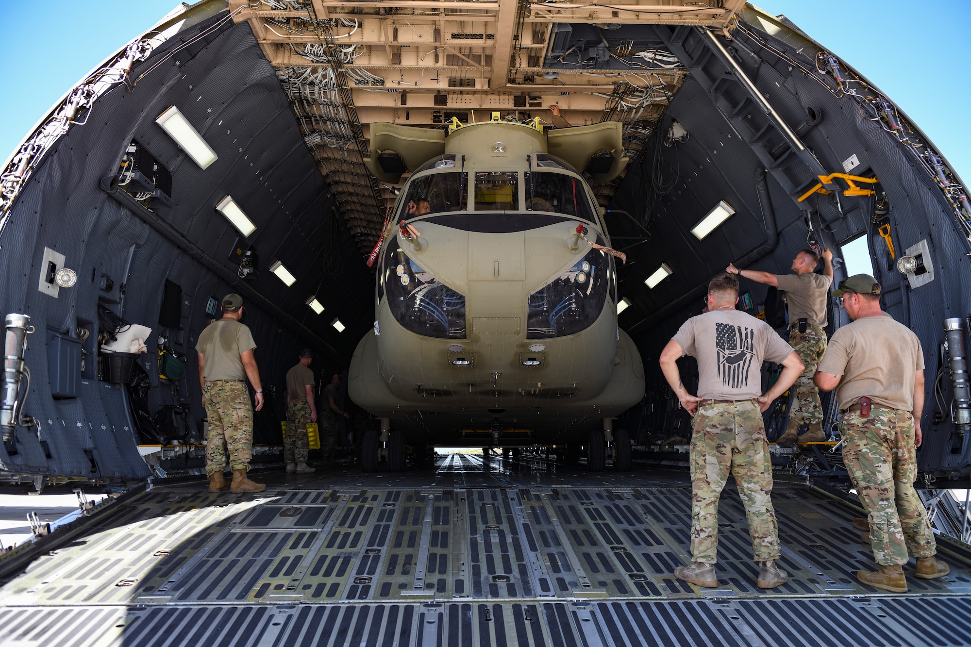 Soldiers load a CH-47 Chinook helicopter into a C-5 Super Galaxy.