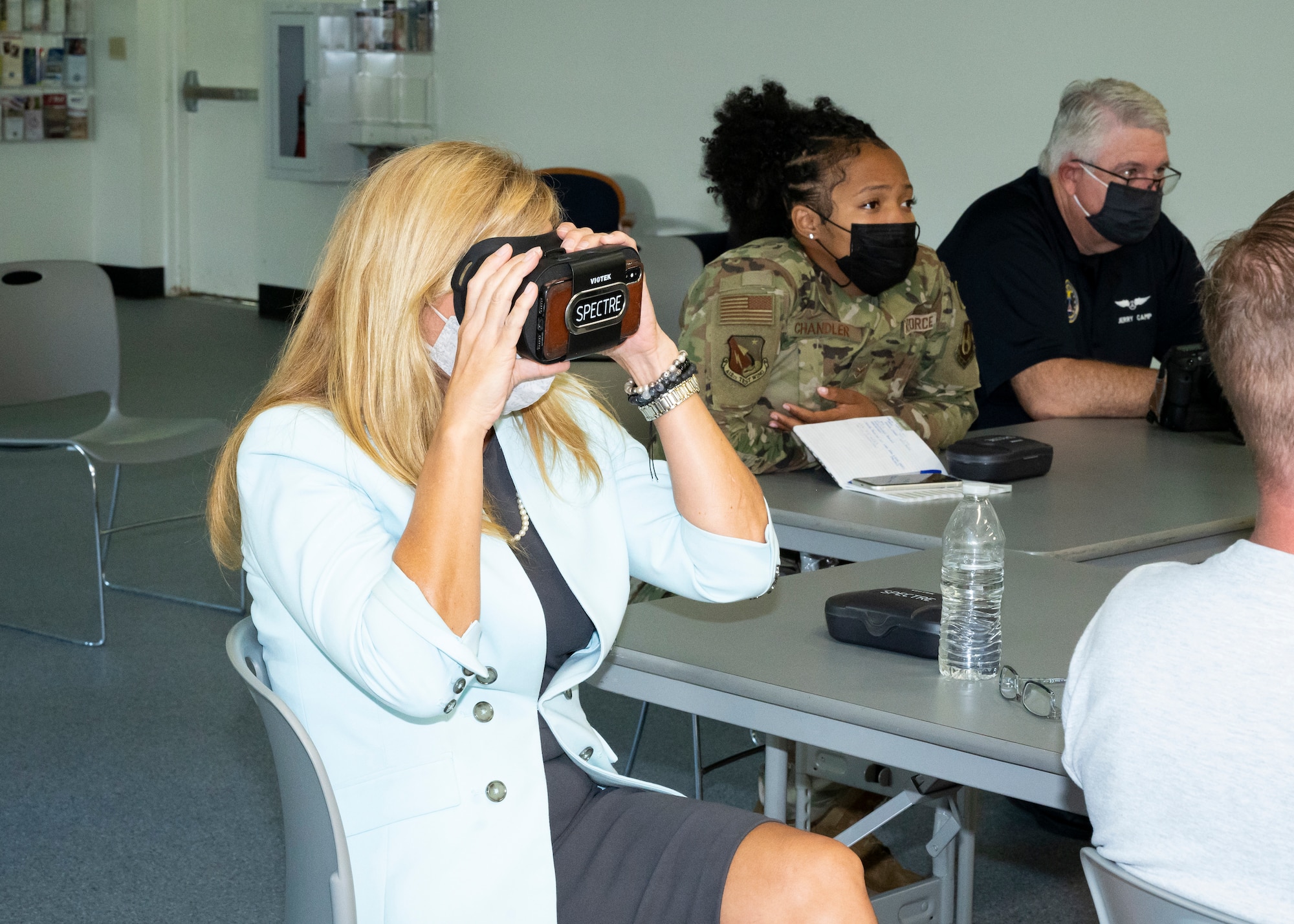 Julie Wilbanks, the Edwards AFB Community Support Coordinator, tests a virtual reality headset during a training session for "The Third Room," a software platform that allows Airmen and civilians to interface with chaplains in a remote and even anonymous manner, at Edwards Air Force Base, California, Sept. 10. (Air Force photo by Katherine Franco)
