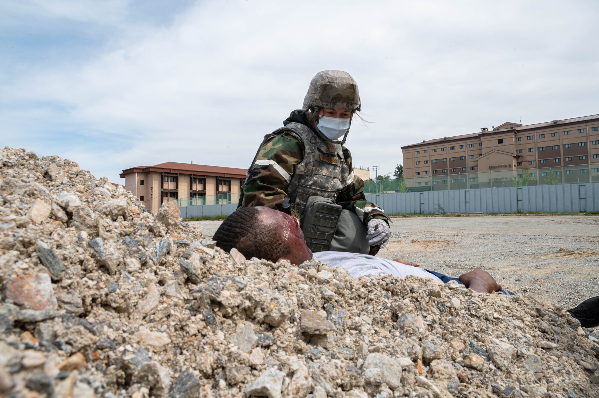 Capt. Danielle Miltenberg from the 51st Medical Group hears cries from an injured member and responds during a mass casualty training event