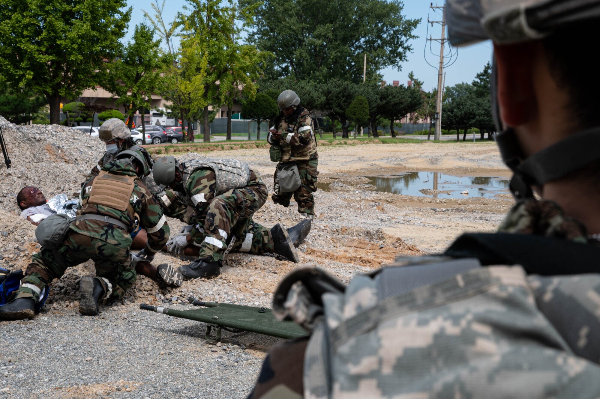 Airmen from the 51st Medical Group treat a patient’s mock injuries during a mass casualty training event