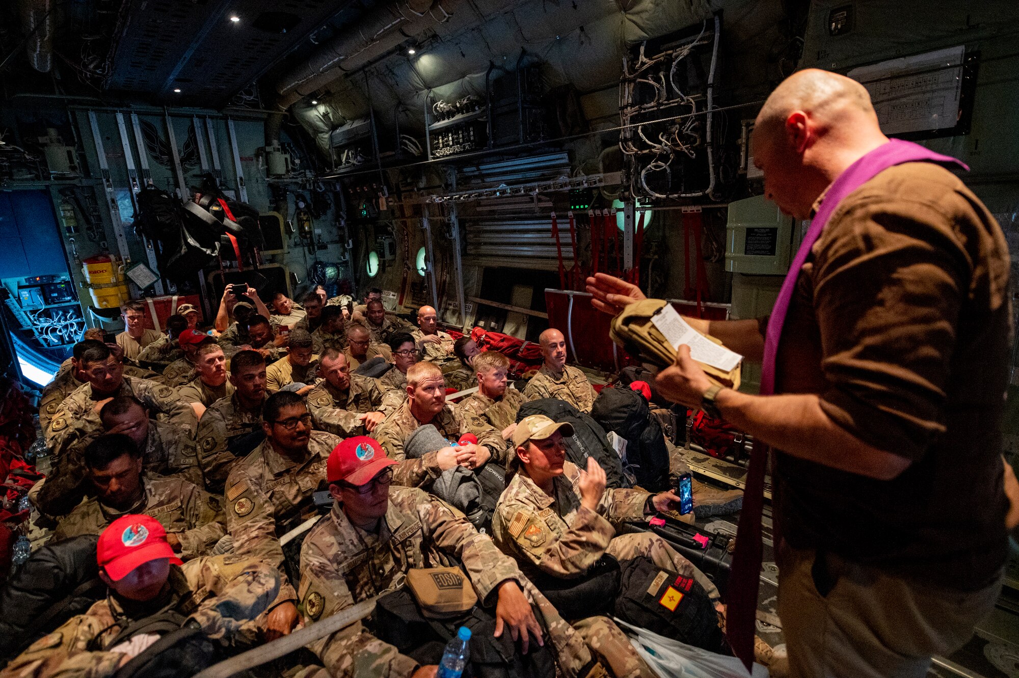 Airmen sit on a U.S. Air Force aircraft