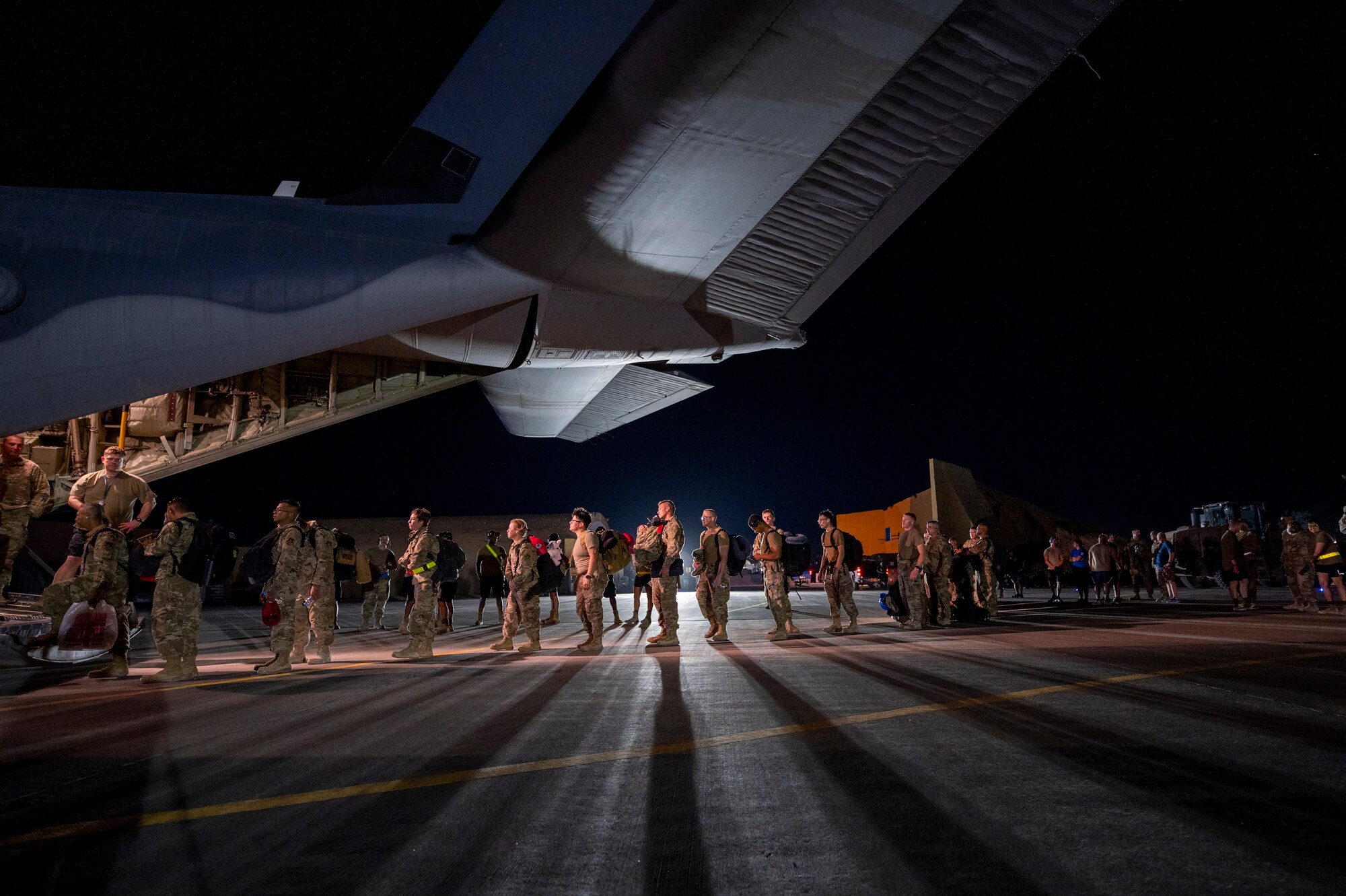 Airmen onload onto a U.S. Air Force aircraft