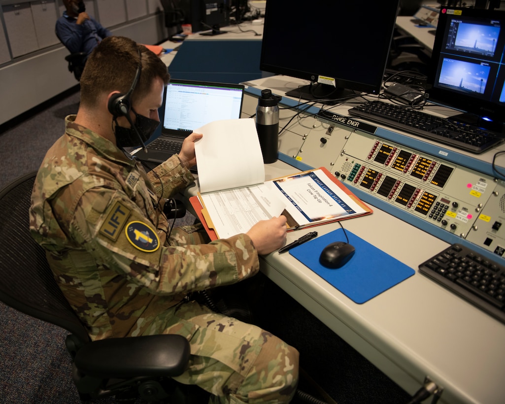 U.S. Space Force 1st Lt. Stephen Pitre, 1st Range Operations Squadron range engineer, reviews mission information in support of the Inspiration4 launch Sept. 15, 2021, inside the Morrell Operations Center at Cape Canaveral Space Force Station, Florida. The MOC supports every space launch from CCSFS and Kennedy Space Center. (U.S. Space Force photo by Tech. Sgt. James Hodgman)