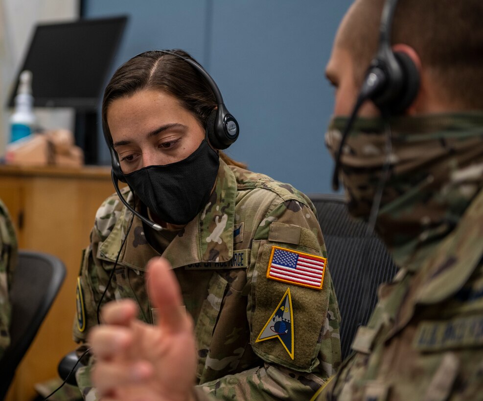 U.S. Space Force 2nd Lt. Taylor Schoephoerster, left, 1st Range Operations Squadron trainee, reviews checklists with Capt. Michael Brooks, 1st ROPS sea surveillance officer, in support of the Inspiration4 launch Sept. 15, 2021, inside the Morrell Operations Center at Cape Canaveral Space Force Station, Florida. The MOC supports every space launch from CCSFS and Kennedy Space Center. (U.S. Space Force photo by Tech. Sgt. James Hodgman)
