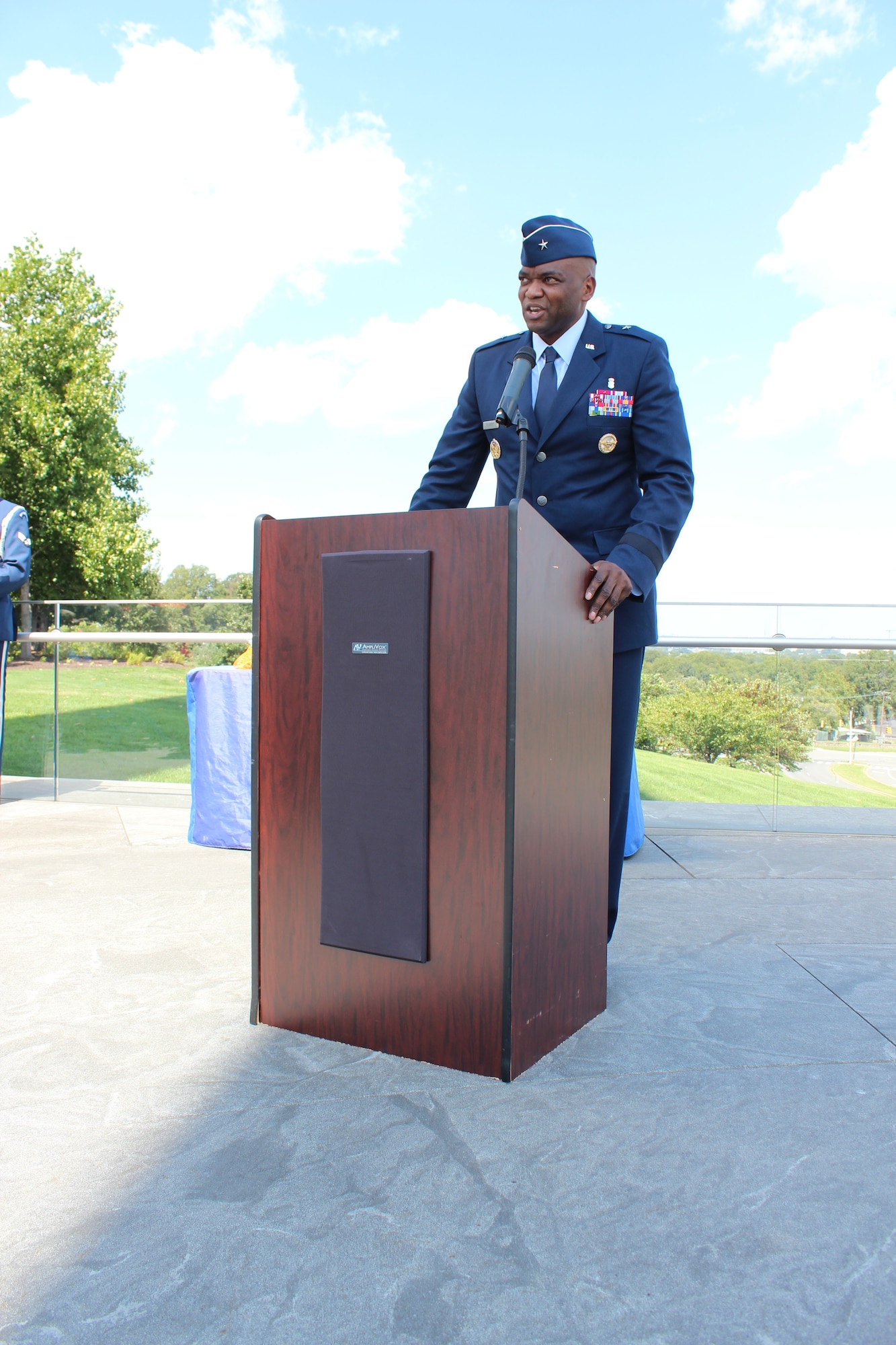 Image of an Airman talking at a podium.