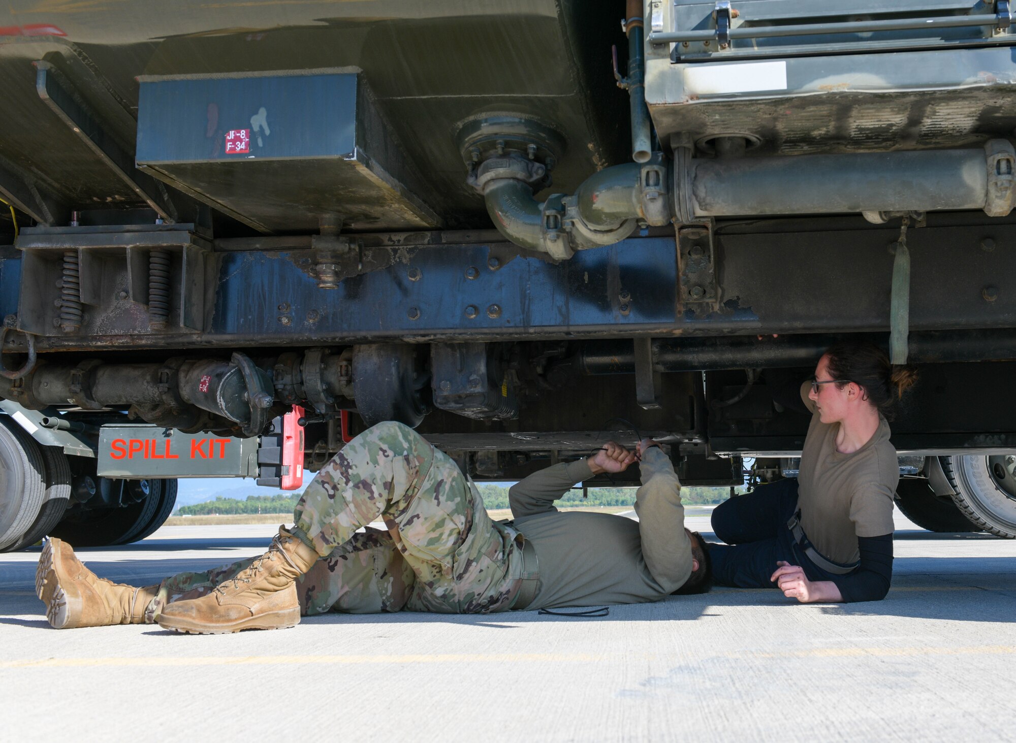U.S. Air Force Airman 1st Class Sergio Dorado, 31st Civil Engineer Squadron electric power production technician, and Staff Sgt. Emily Scully, 31st Logistics Readiness Squadron fire truck and refueling maintenance technician, close valves on a refueler truck at Cerklje ob Krki Air Base, Slovenia, Sept. 9, 2021. Refueler trucks are used to refuel aircraft and they can carry approximately 6,000 gallons of fuel. (U.S. Air Force photo by Senior Airman Brooke Moeder)