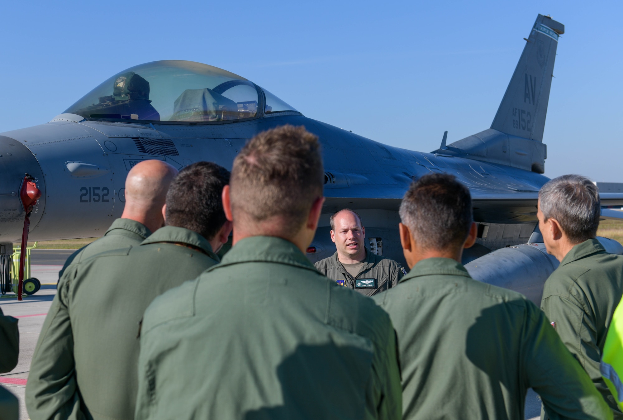 U.S. Air Force Lt. Col. Daniel O’Neil, 555th Fighter Squadron director of operations, briefs Slovenian Armed Forces members about a U.S. Air Force F-16 Fighting Falcon during exercise Agile Wyvern at Cerklje ob Krki Air Base, Slovenia, Sept. 10, 2021. O’Neil briefed the SAF members about the mission and capability of the F-16 and provided general knowledge about the aircraft. (U.S. Air Force photo by Senior Airman Brooke Moeder)