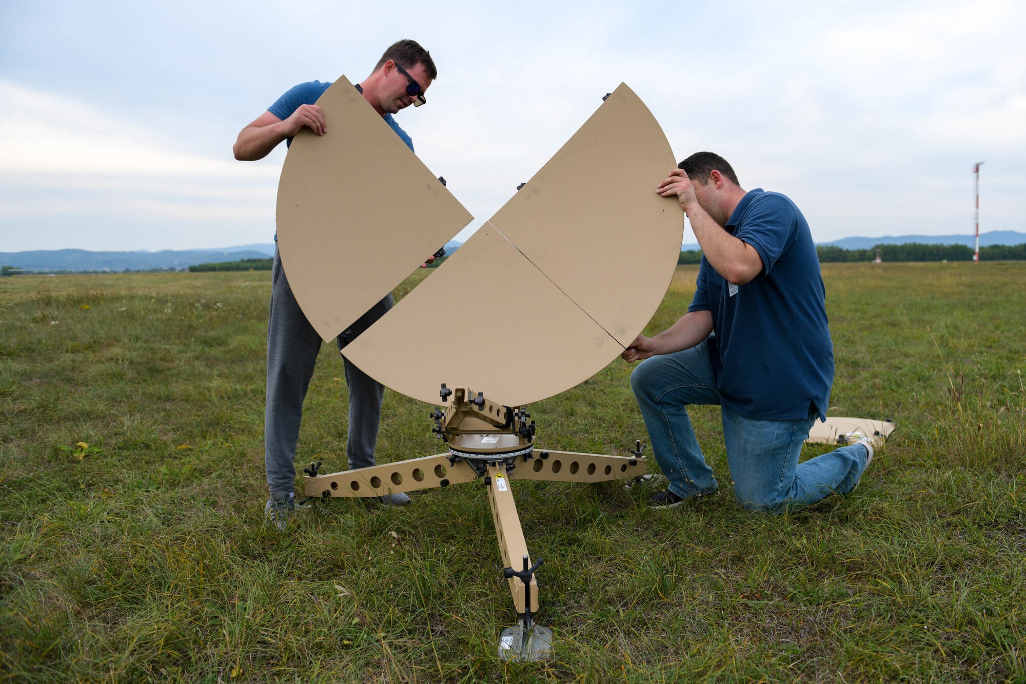 Airman 1st Class Shane Moehle, 31st Communications Squadron radio frequency transition technician, and U.S. Air Force Staff Sgt. Keeling Weber, 31st CS RF transmission supervisor, assemble a Ranger Airbus satellite in preparation for exercise Agile Wyvern at Cerklje ob Krki Air Base, Slovenia, Sept. 7, 2021. The Ranger Airbus allowed for satellite communications and secure messaging capabilities during Agile Wyvern. (U.S. Air Force photo by Senior Airman Brooke Moeder)