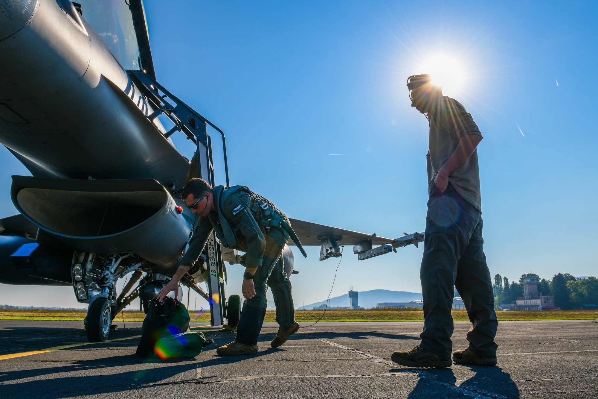 U.S. Air Force 1st Lt. Ryan Kitching, 555th Fighter Squadron F-16 Fighting Falcon pilot, and a U.S. Air Force F-16 crew chief assigned to the 555th Aircraft Maintenance Unit prepare to participate in Agile Wyvern at Cerklje ob Krki Air Base, Slovenia, Sept. 8, 2021. During Agile Wyvern, U.S. and Slovenian Armed Forces conducted Agile Combat Employment training. (U.S. Air Force photo by Senior Airman Brooke Moeder)