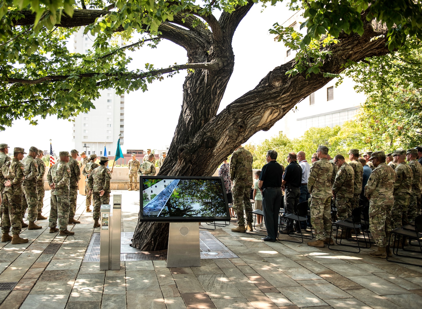 Members of the Oklahoma National Guard, community partners and family members gather around the Murrah Bombing Survivor Tree during a change of command ceremony at the Oklahoma City National Memorial and Museum in Oklahoma City, Sept. 1, 2021.  The 63rd CST is designed to provide a specialized response to chemical, biological, radiological or nuclear incidents at the authorization and direction of the Governor.