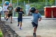 Master Sgt.  Kristen Roles with the Kentucky Air National Guard 123rd Maintenance Squadron prepares to attempt an overhead press as part of an exercise drill at Boone National Guard Center on Sept. 7th, 2021. As part of the AXE Camp’s cadre team, her role is to instruct students on proper physical exercise techniques and holistic health strategies.