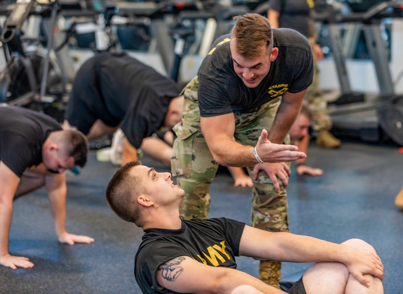 Master Sgt.  Kristen Roles with the Kentucky Air National Guard 123rd Maintenance Squadron prepares to attempt an overhead press as part of an exercise drill at Boone National Guard Center on Sept. 7th, 2021. As part of the AXE Camp’s cadre team, her role is to instruct students on proper physical exercise techniques and holistic health strategies.