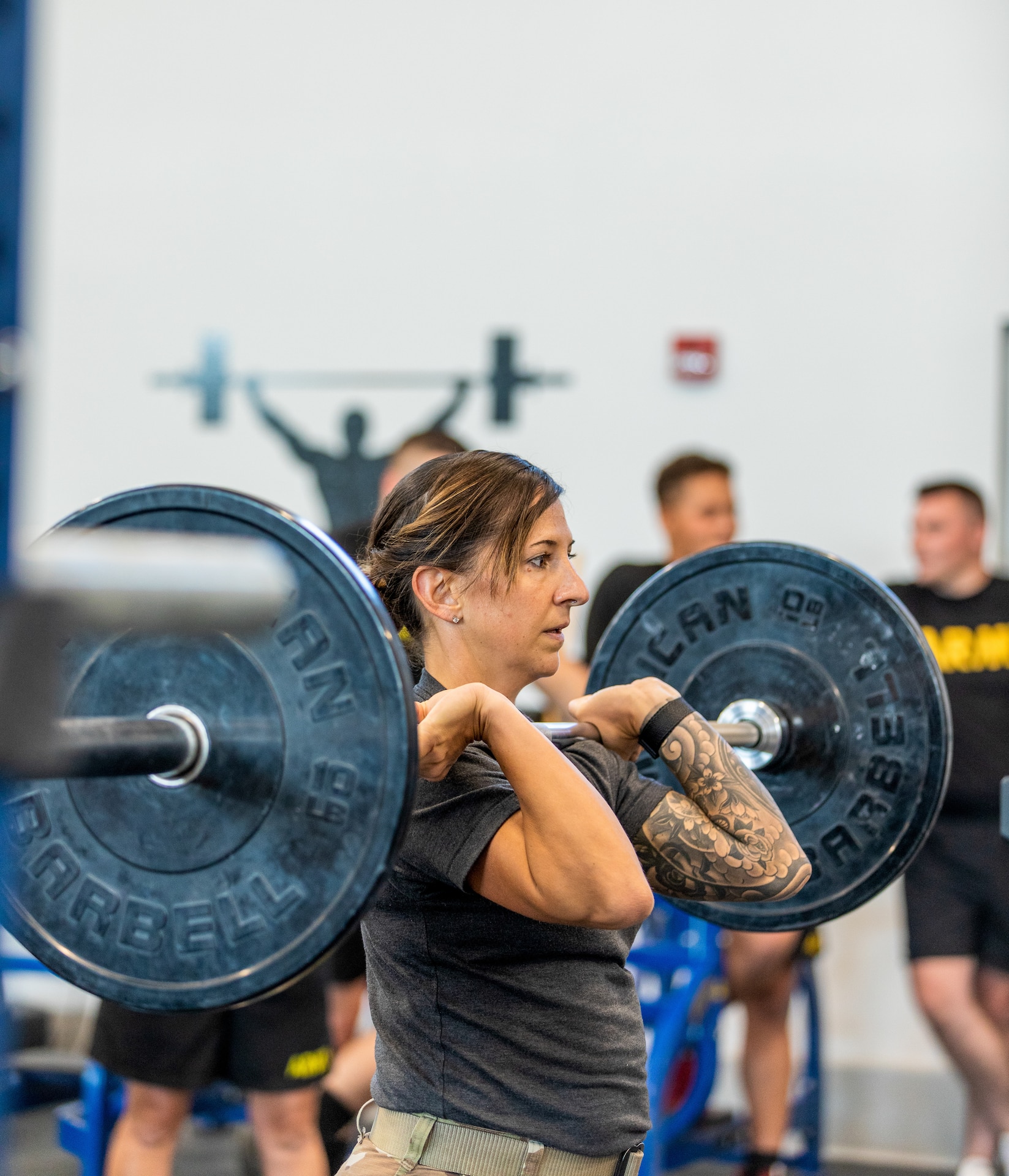 Master Sgt.  Kristen Roles with the Kentucky Air National Guard 123rd Maintenance Squadron prepares to attempt an overhead press as part of an exercise drill at Boone National Guard Center on Sept. 7th, 2021. As part of the AXE Camp’s cadre team, her role is to instruct students on proper physical exercise techniques and holistic health strategies.
