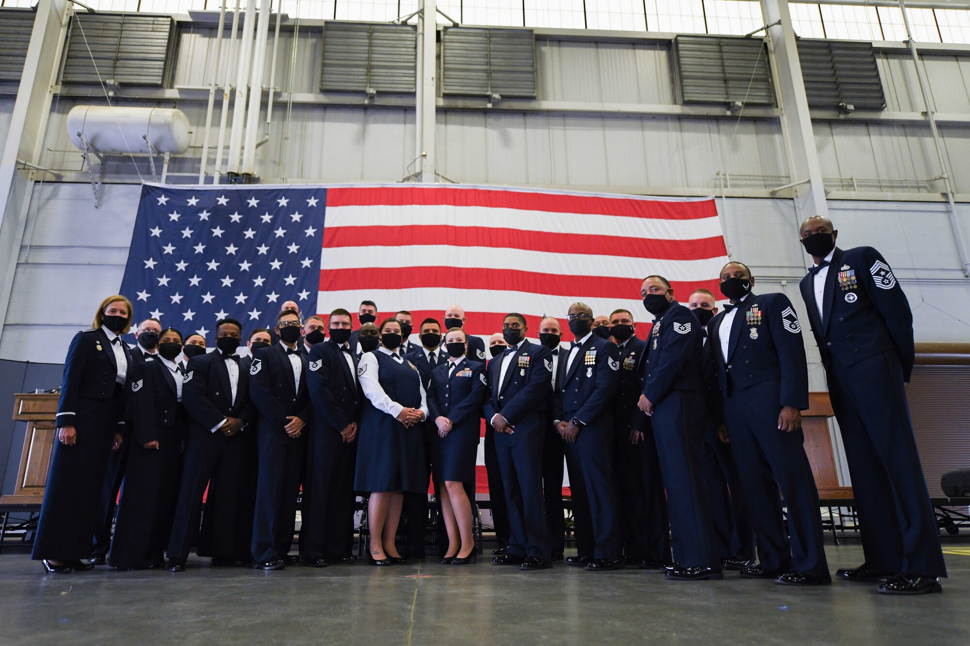 Inductees stand during a senior noncommissioned officer induction ceremony in the Peacekeeper High Bay on F.E. Warren Air Force Base, Wyoming, Sept. 10, 2021. Inductees transitioned from technical experts and first-line supervisors of their field to operational leaders.