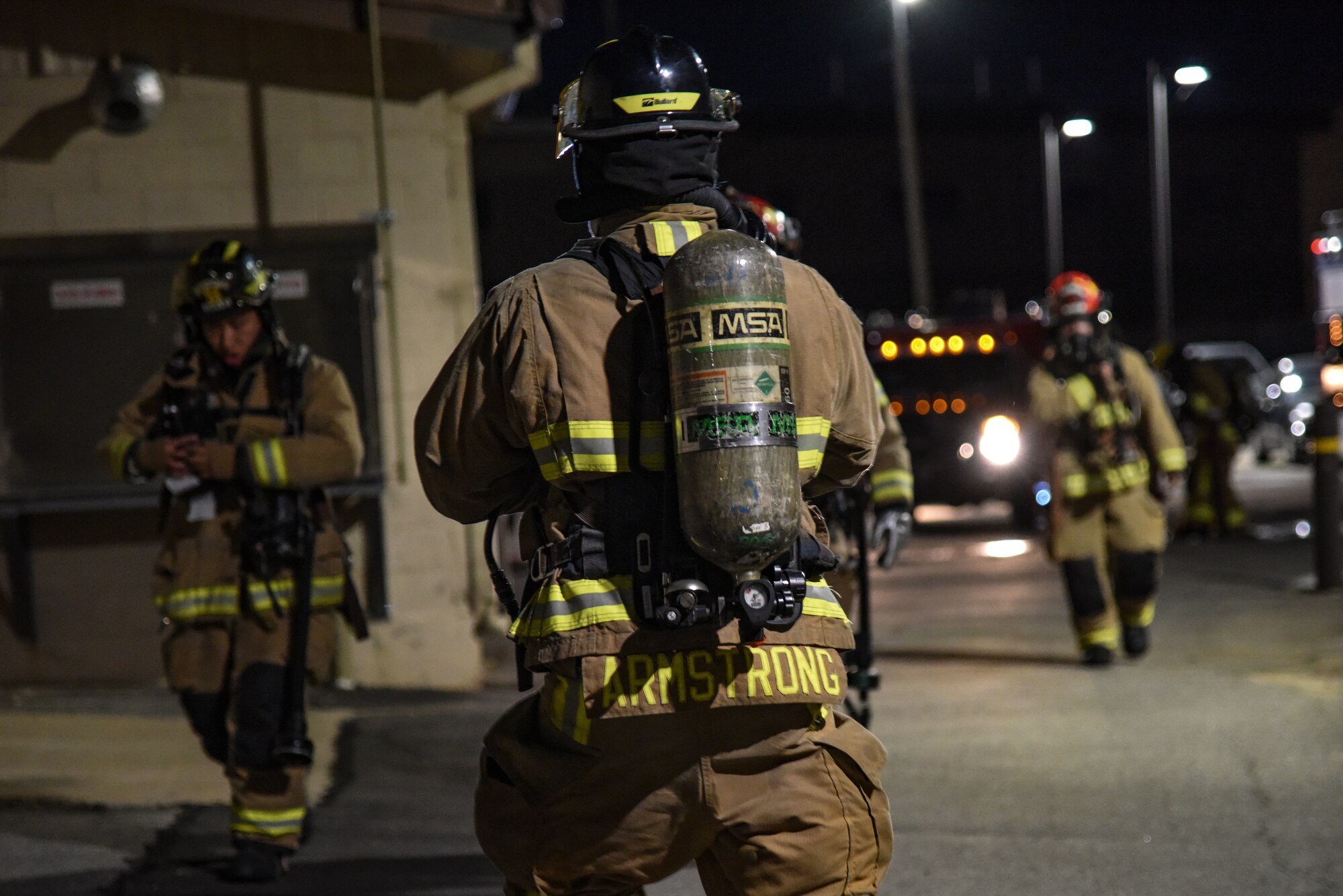 Firefighters from the 51st Civil Engineer Squadron gear up before a scenario during a training event