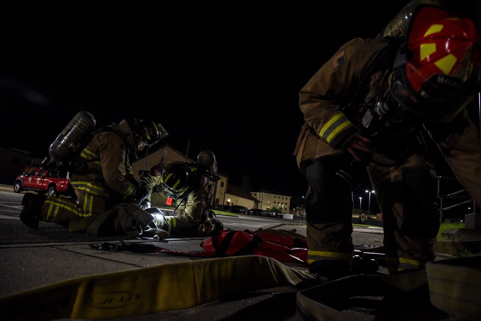 Firefighters from the 51st Civil Engineer Squadron arrange equipment during a training event