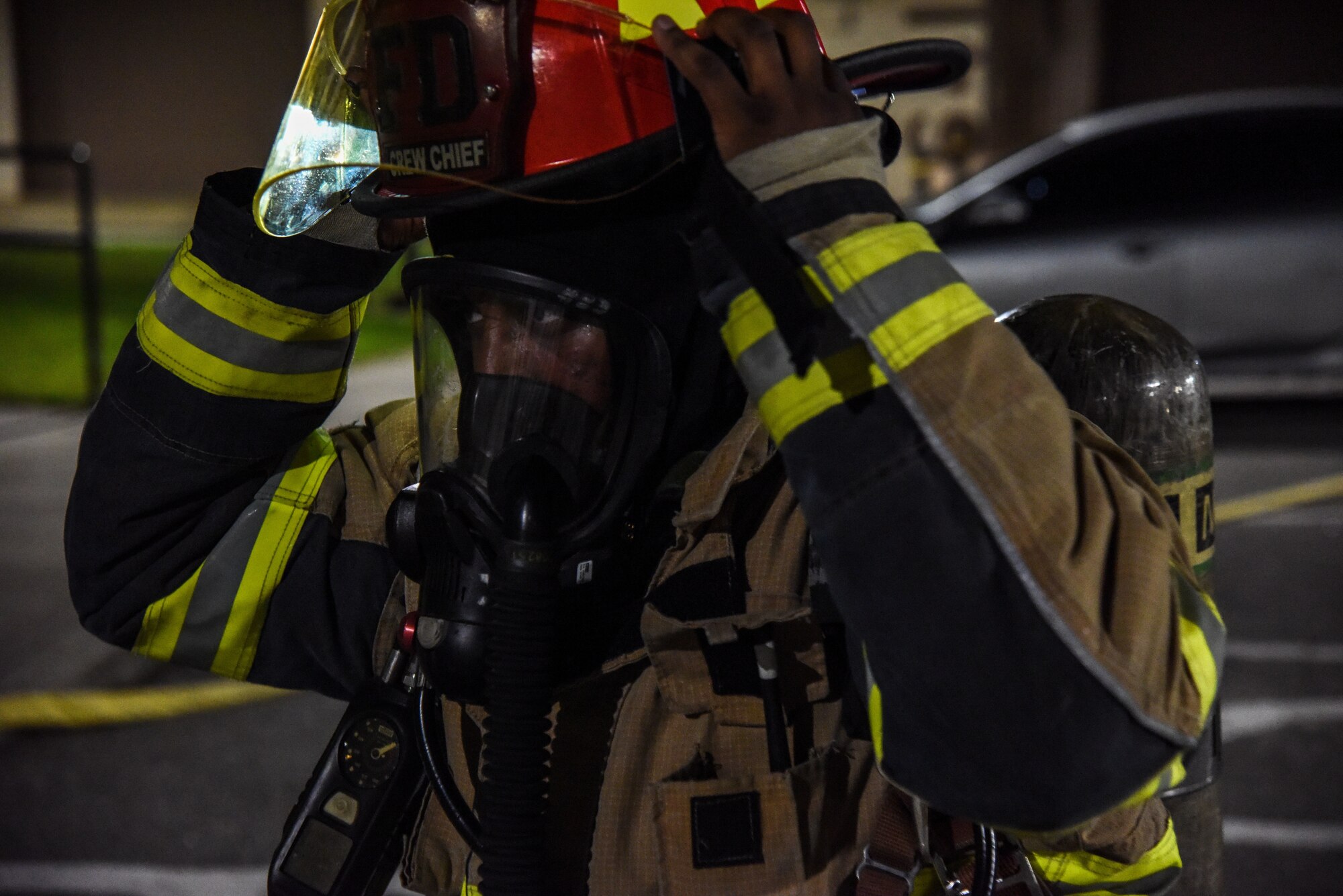 Staff Sgt. Tyler McFarland, 51st Civil Engineer Squadron firefighter, dons his fire protection equipment during a training event