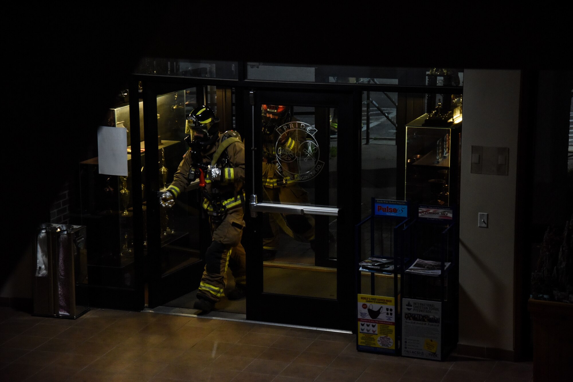 Firefighters from the 51st Civil Engineer Squadron enter a building during a training event