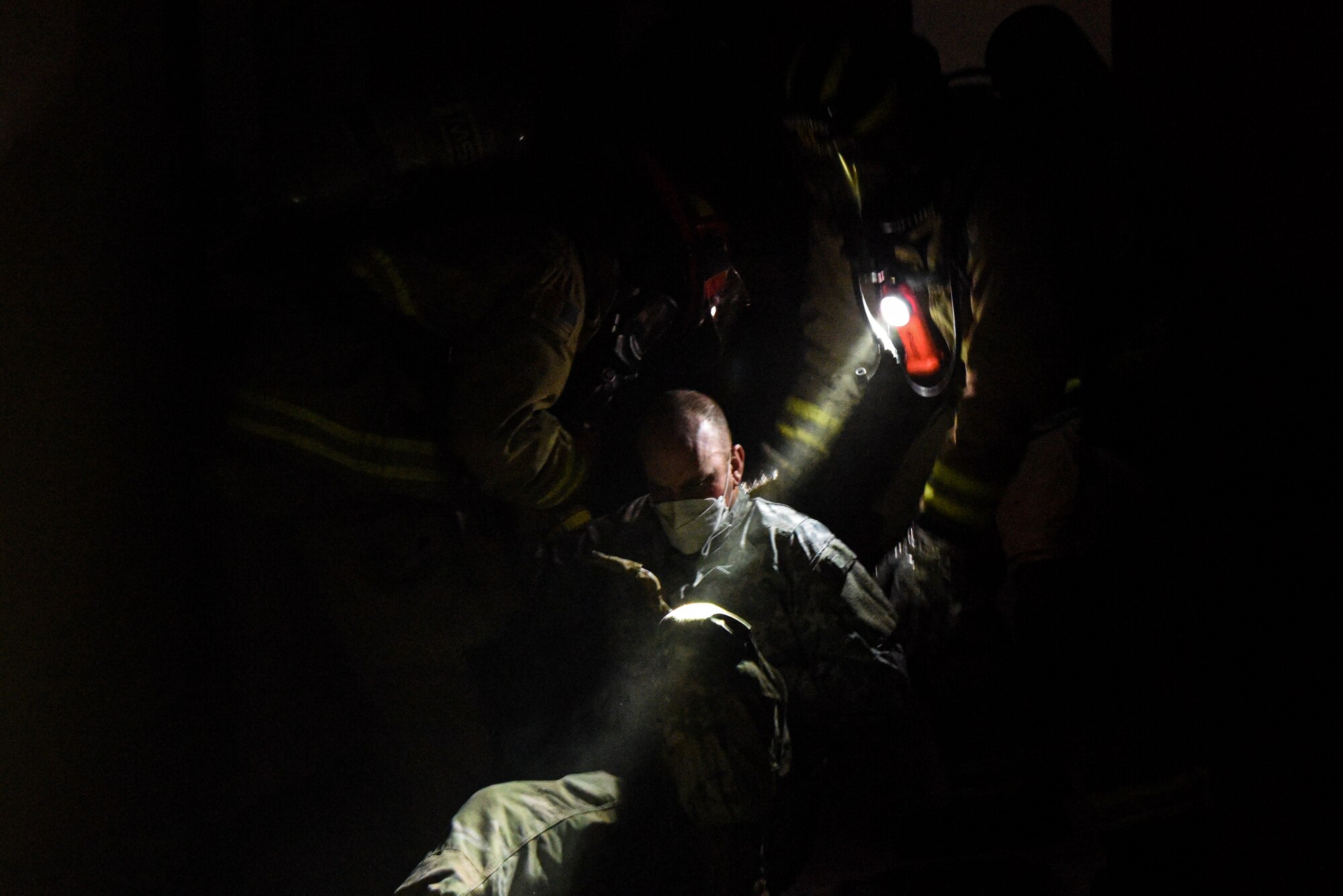 Firefighters from the 51st Civil Engineer Squadron discover a wounded Airman during a training scenario