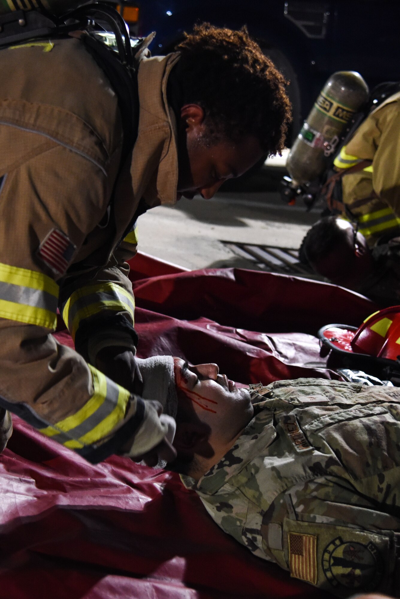 Staff Sgt. Tyler McFarland, 51st Civil Engineer Squadron firefighter, provides first aide to a wounded Airman during a training event