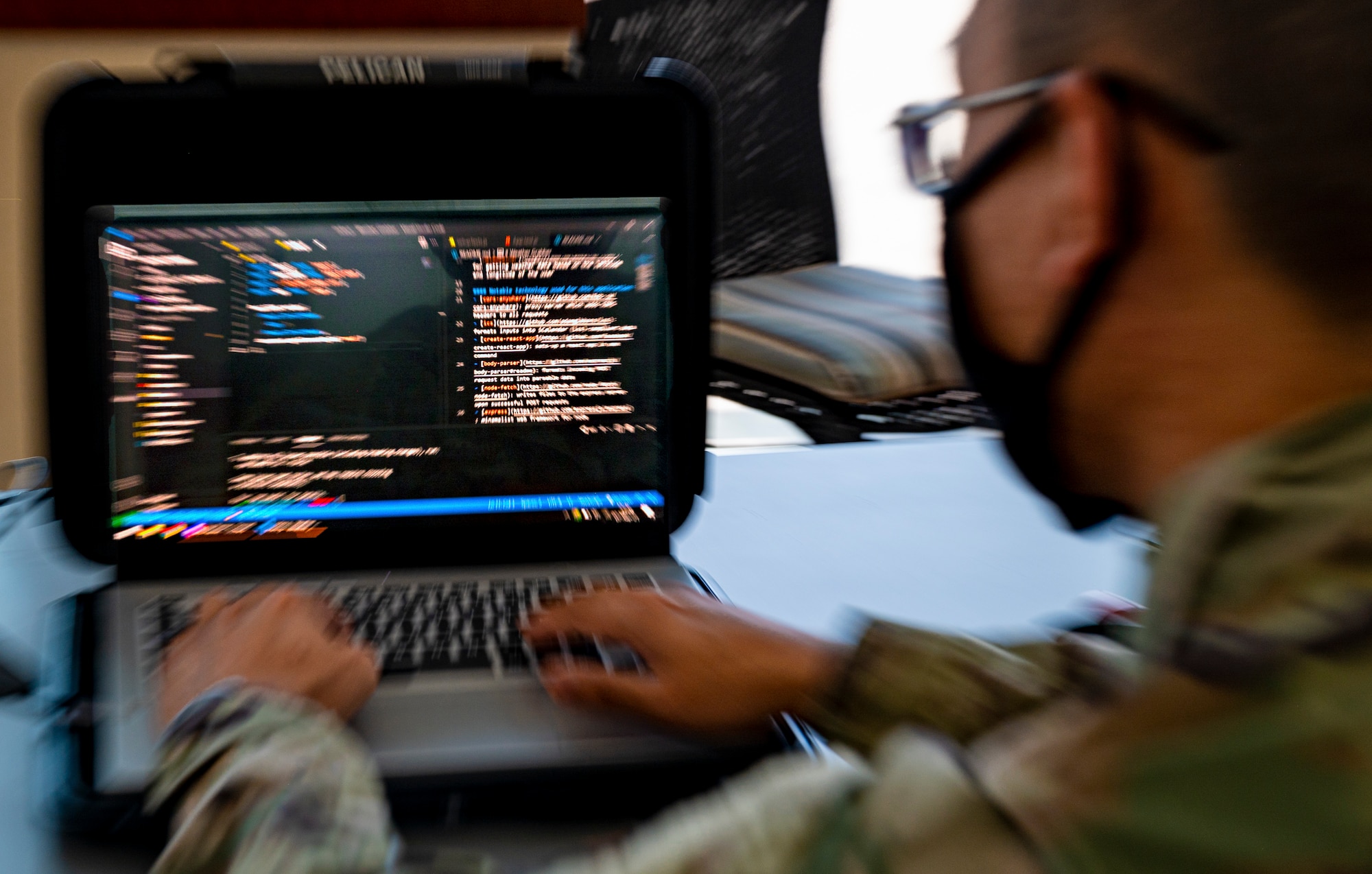 Photo of a man typing on a laptop.