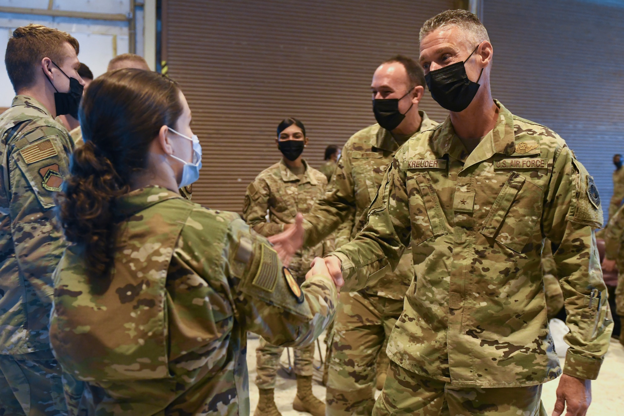 U.S. Air Force Brig. Gen. Gregory Kreuder, far right, 56th Fighter Wing commander, and U.S. Air Force Chief Master Sgt. Daniel Weimer, 56th FW command chief, offer well wishes to 56th FW Airmen ahead of a temporary deployment to Joint Base McGuire-Dix-Lakehurst, New Jersey, Sept. 13, 2021, at Luke Air Force Base, Arizona. More than 40 Airmen from the 56th FW deployed to JB MDL in support of Operation Allies Welcome, where they will assist with medical screenings, lodging, and other general support services for Afghan evacuees.. Luke Airmen rapidly mobilized to answer the call for support with less than a four-day notice to assist with the sheltering of thousands of Afghan evacuees from Kabul, Afghanistan. (U.S. Air Force photo by Tech. Sgt. Amber Carter)