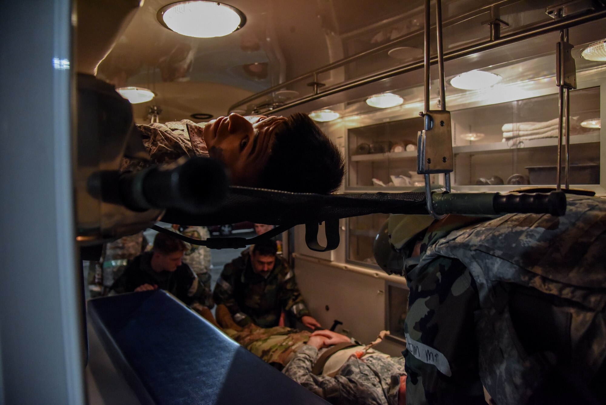 Airman 1st Class George Molina, 51st Civil Engineer Squadron augmentee, looks out of an ambulance as 51st CES firefighters and the 51st Medical Group Field Response Team load injured Airmen during a training event