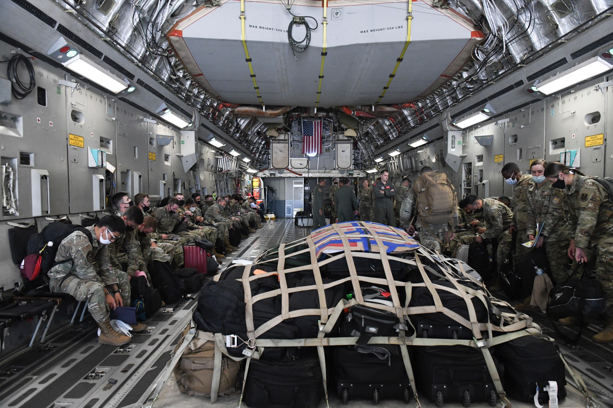 U.S. Airmen from the 56th Fighter Wing board a C-17 Globemaster III Sept. 13, 2021, at Luke Air Force Base, Arizona. The C-17 from Altus Air Force Base, Oklahoma, will be transporting more than 40 Luke Airmen to Joint Base McGuire-Dix-Lakehurst, New Jersey, in support of Operation Allies Welcome. They will assist with medical screenings, lodging, and other general support services for Afghan evacuees. Luke Airmen rapidly mobilized to answer the call for support with less than a four-day notice to assist with the sheltering of thousands of Afghan evacuees from Kabul, Afghanistan. (U.S. Air Force photo by Tech. Sgt. Amber Carter)