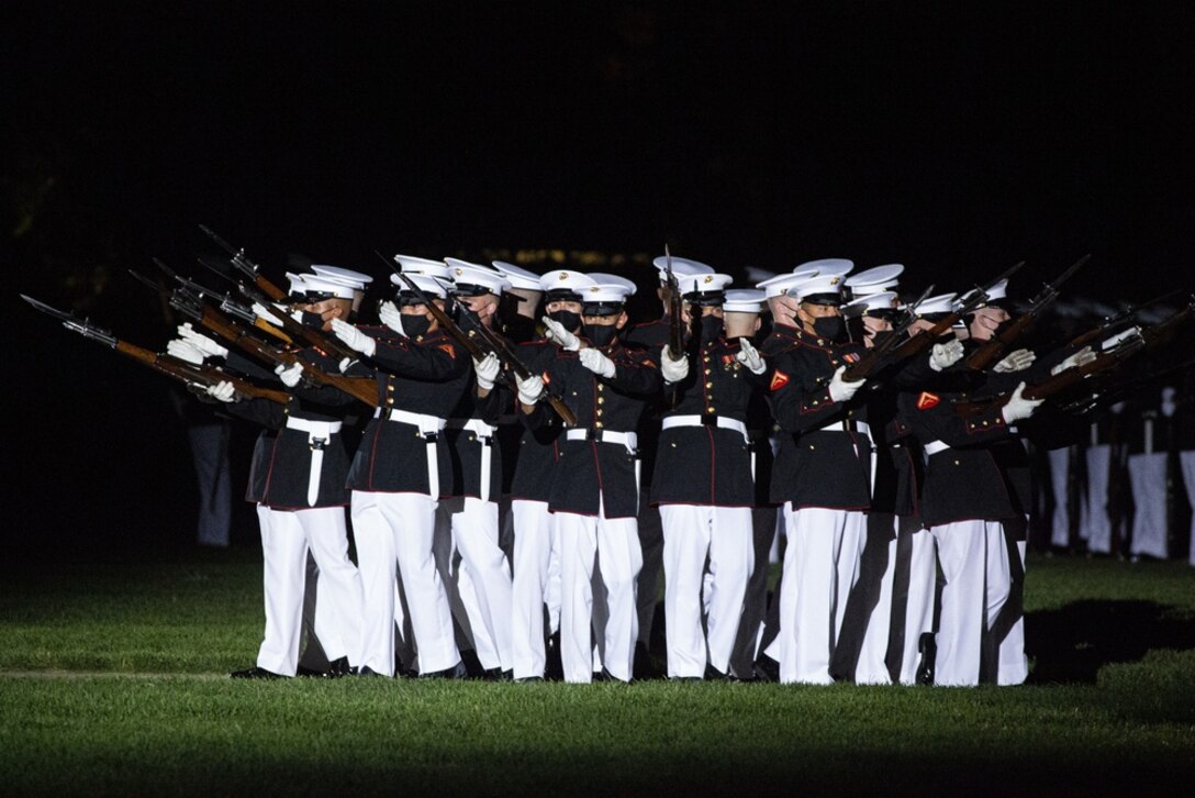 Marines with the Silent Drill Platoon perform their “bursting bomb” sequence during the Friday Evening Parade at Marine Barracks Washington, June 4, 2021. The guest of honor for the evening was The Honorable Michèle A. Flournoy, 9th Undersecretary of Defense for Policy, and the hosting official for the evening was Lt. Gen. Charles G. Chiarotti, Deputy Commandant for Installations and Logistics.
