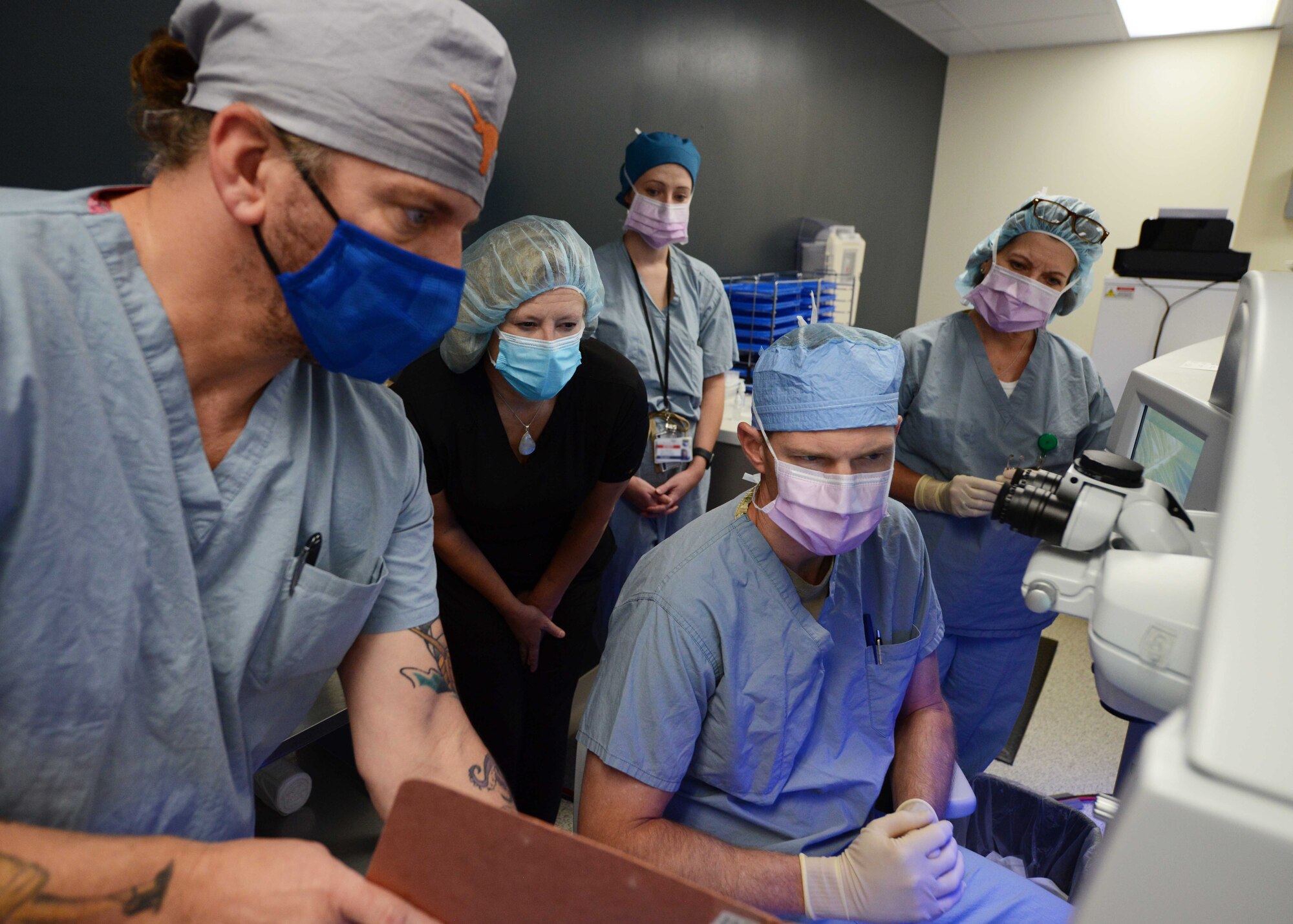 Lt. Col. Marcus Neuffer (center), chief surgeon assigned to the 10th Medical Group, Air Force Academy, Colo., and his staff, evaluates a patient during a small incisional lenticular extraction (SMILE) eye surgery, Aug. 19, 2021.