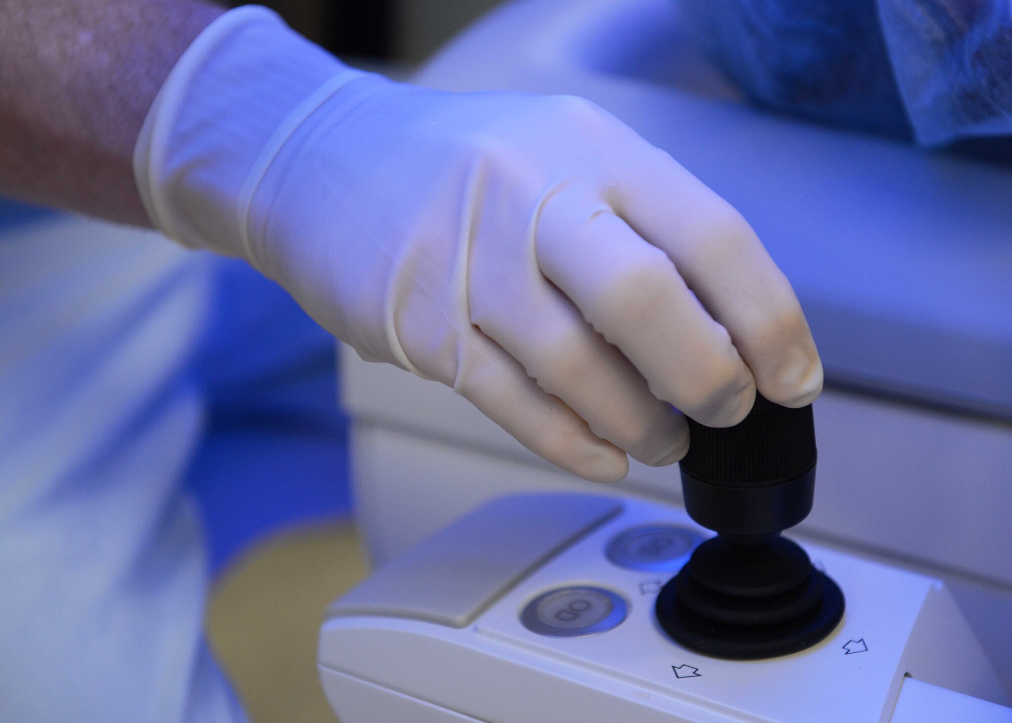 Lt. Col. Marcus Neuffer, chief surgeon assigned to the 10th Medical Group, Air Force Academy, Colo., manipulates a joystick to position the patient into place during a small incisional lenticular extraction (SMILE) eye surgery, Aug. 19, 2021.