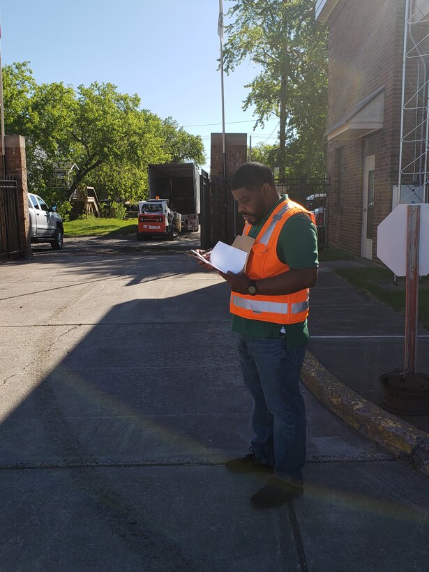 Torrence Butts, general supply specialist, arranges the Logistics Office team’s removal of excess and unserviceable equipment from area offices.