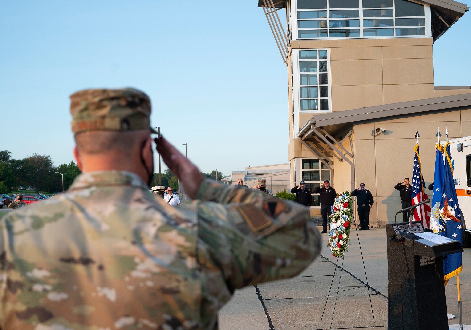 Col. Patrick Miller, 88th Air Base Wing and installation commander, salutes Sept. 10, 2021, during the playing of taps at the Wright-Patterson Air Force Base, Ohio, ceremony commemorating the 20th anniversary of the 9/11 attacks. Miller gave the keynote address, praising heroics of the first responders that day and how they continue to inspire. (U.S. Air Force photo by R.J. Oriez)
