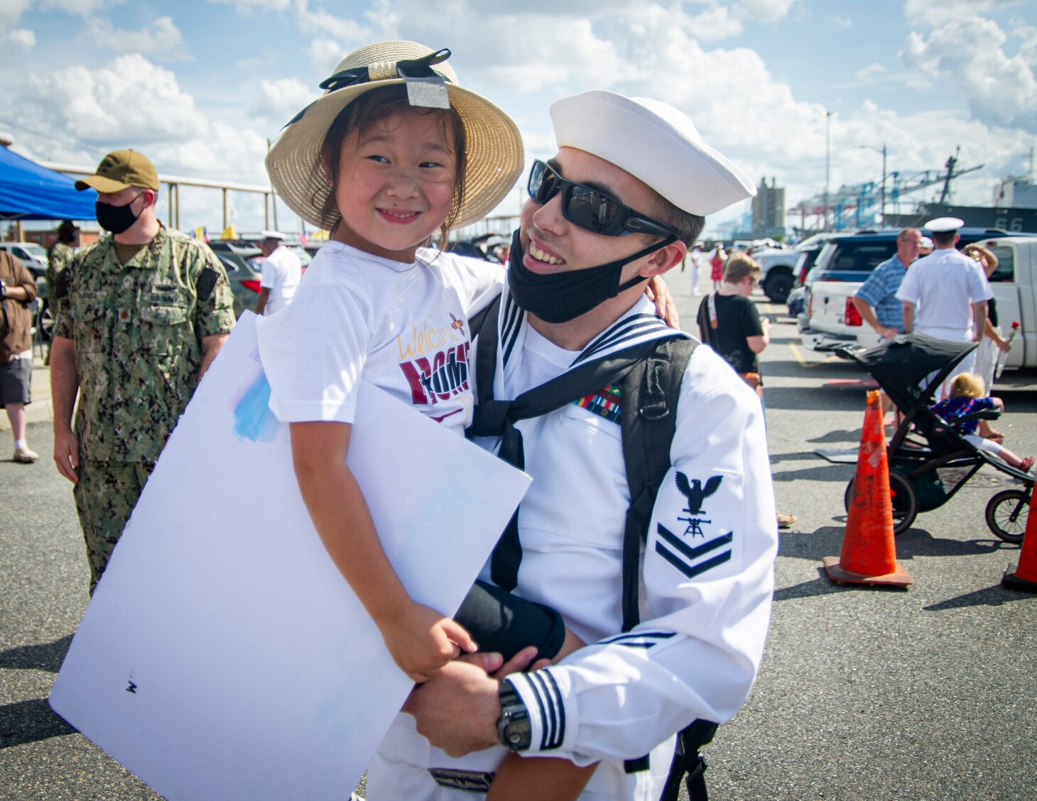 Fire Control Technician 1st Class Patrick Martin, assigned to the Virginia-Class fast-attack submarine USS New Mexico (SSN 779), holds his daughter during the boat’s homecoming at Naval Station Norfolk, Sept. 15, 2021.