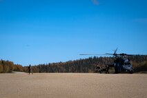 U.S. Airmen assigned to the 673rd Medical Group carry a go-bag of medical supplies and equipment during a Capabilities-Based Assessment (CBA) at the Yukon Training Area, Sept. 14, 2021.