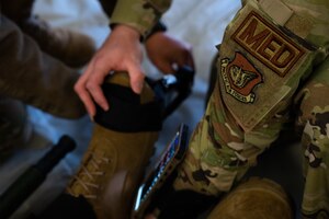 U.S. Airmen assigned to the 354th and 673rd Medical Group apply a tourniquet to a simulated trauma patient during a Capabilities-Based Assessment (CBA) at the Yukon Training Area, Sept. 14, 2021.