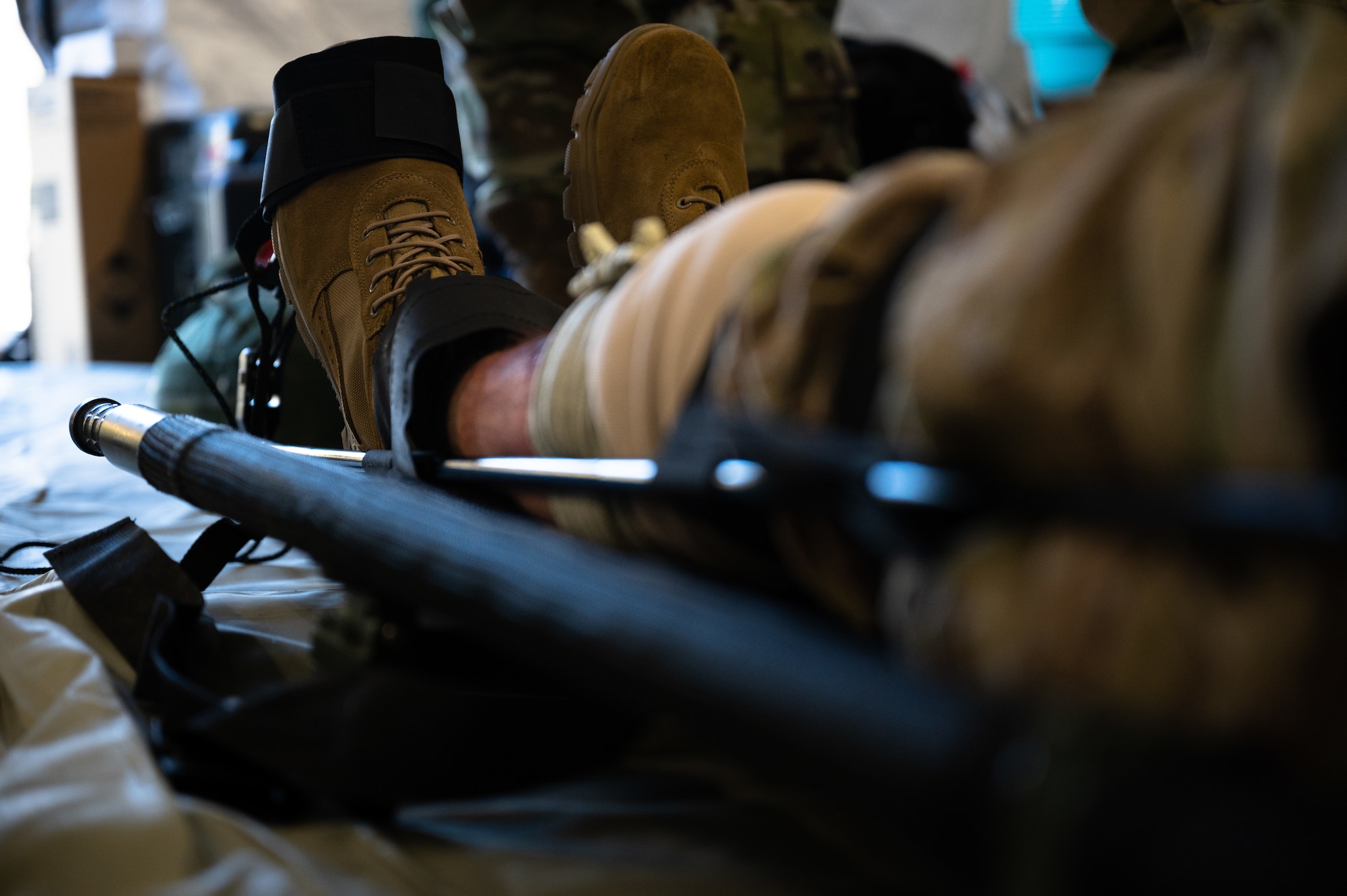 A U.S. Airman assigned to the 354th Fighter Wing acts as a simulated trauma patient during a Capabilities-Based Assessment (CBA) at the Yukon Training Area, Sept. 14, 2021.