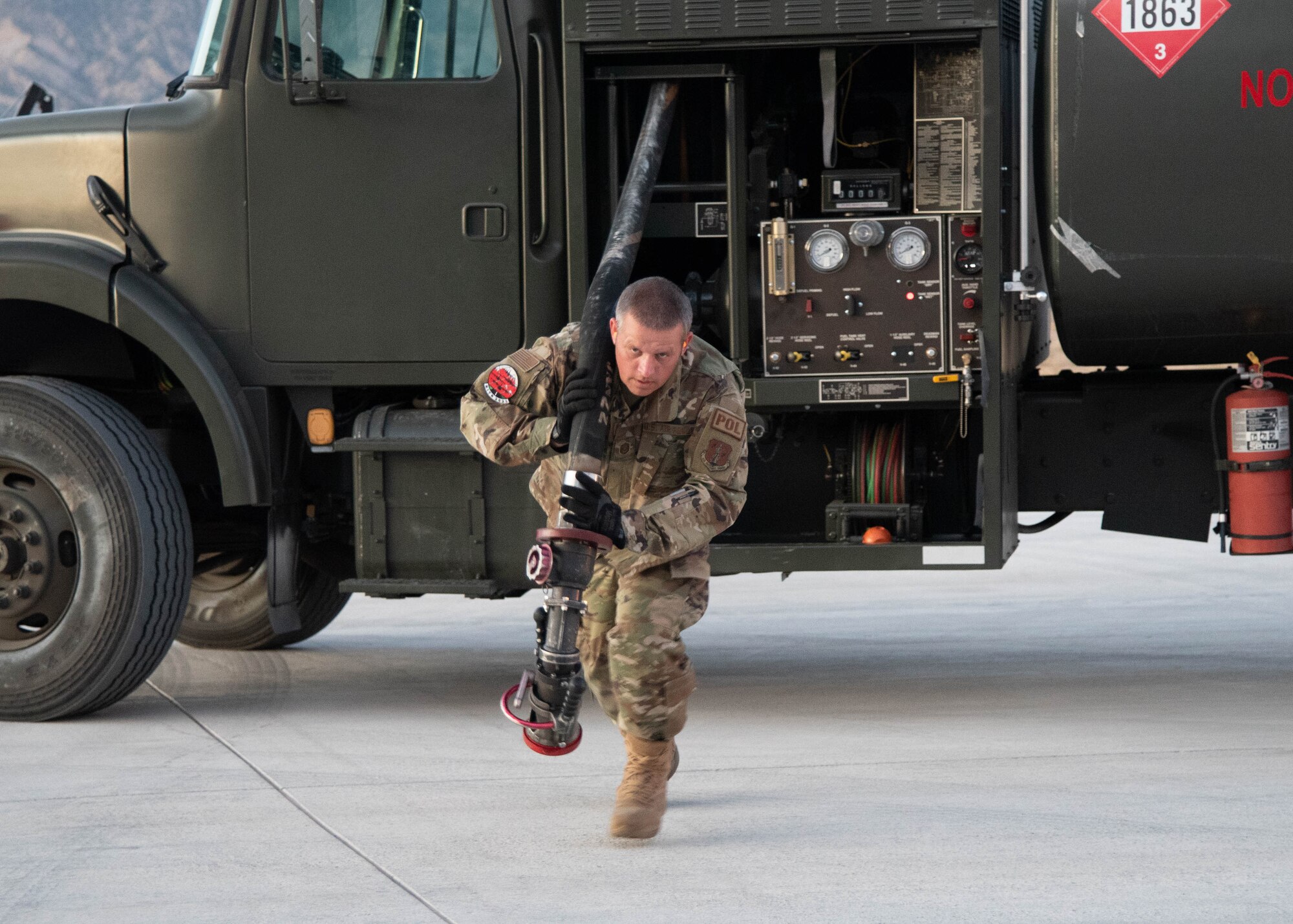 Master Sgt. David Swaney, 153rd Logisitics Readiness Squadron, Wyoming Air National Guard, drags a fuel hose to the aircraft as part of wet-wing defuel training Sept. 13, 2021. Fellow fuels technicans from the active-duty Air Force, Air National Guard and Air Force reservists trained on wet-wing defueling to offload fuel from an aircraft to a refueler truck. The Airmen gathered at Rifle-Garfield County Airport, Rifle, Colorado, to take part in the 22nd Air Force’s flagship exercise Rally in the Rockies Sept. 12-17, 2021. The exercise is designed to develop Airmen for combat operations by challenging them with realistic scenarios that support a full spectrum of operations during military actions, operations or hostile environments.