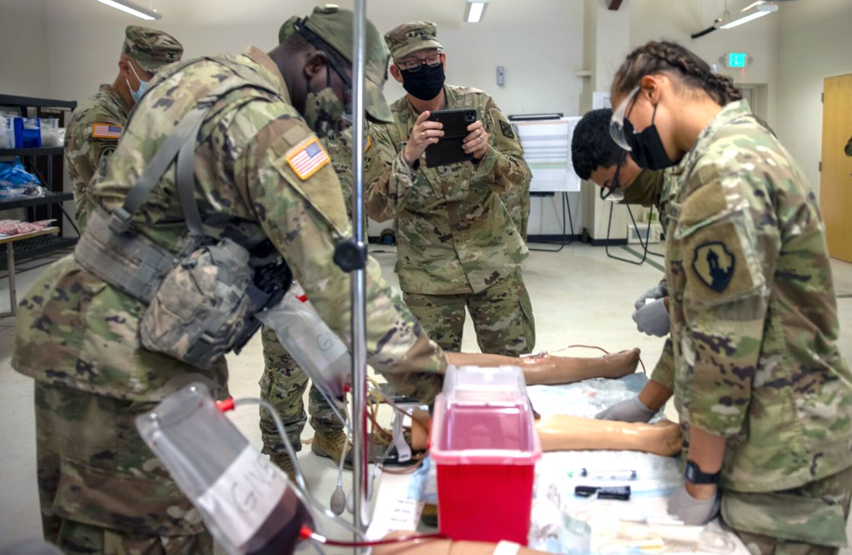 Lt. Gen. Theodore Martin (center), commander of the U.S. Army Combined Arms Center, or CAC, takes a photo of 68W Combat Medic’s training during a culminating Field Training Exercise at the Soldier Medic Training Site, Medical Education and Training Campus, Joint Base San Antonio-Camp Bullis, Sept. 10.