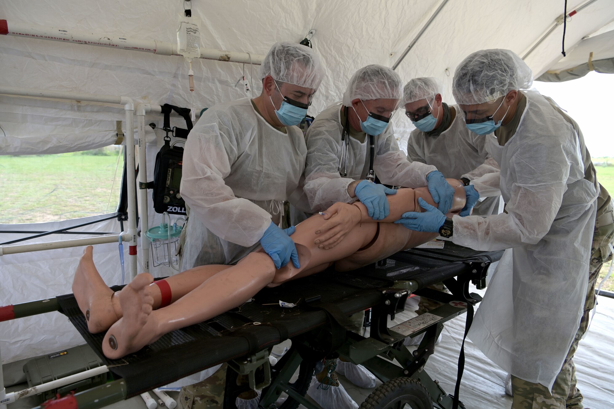 U.S. Air Force medics with the 156th Medical Group Detachment 1, Chemical, Biological, Radiological, Nuclear and high-yield Explosive Enhanced Response Force Package, evaluate and treat a simulated victim during a search and extraction training exercise at Camp Santiago Joint Training Center, Salinas, Puerto Rico, Aug. 19, 2021.