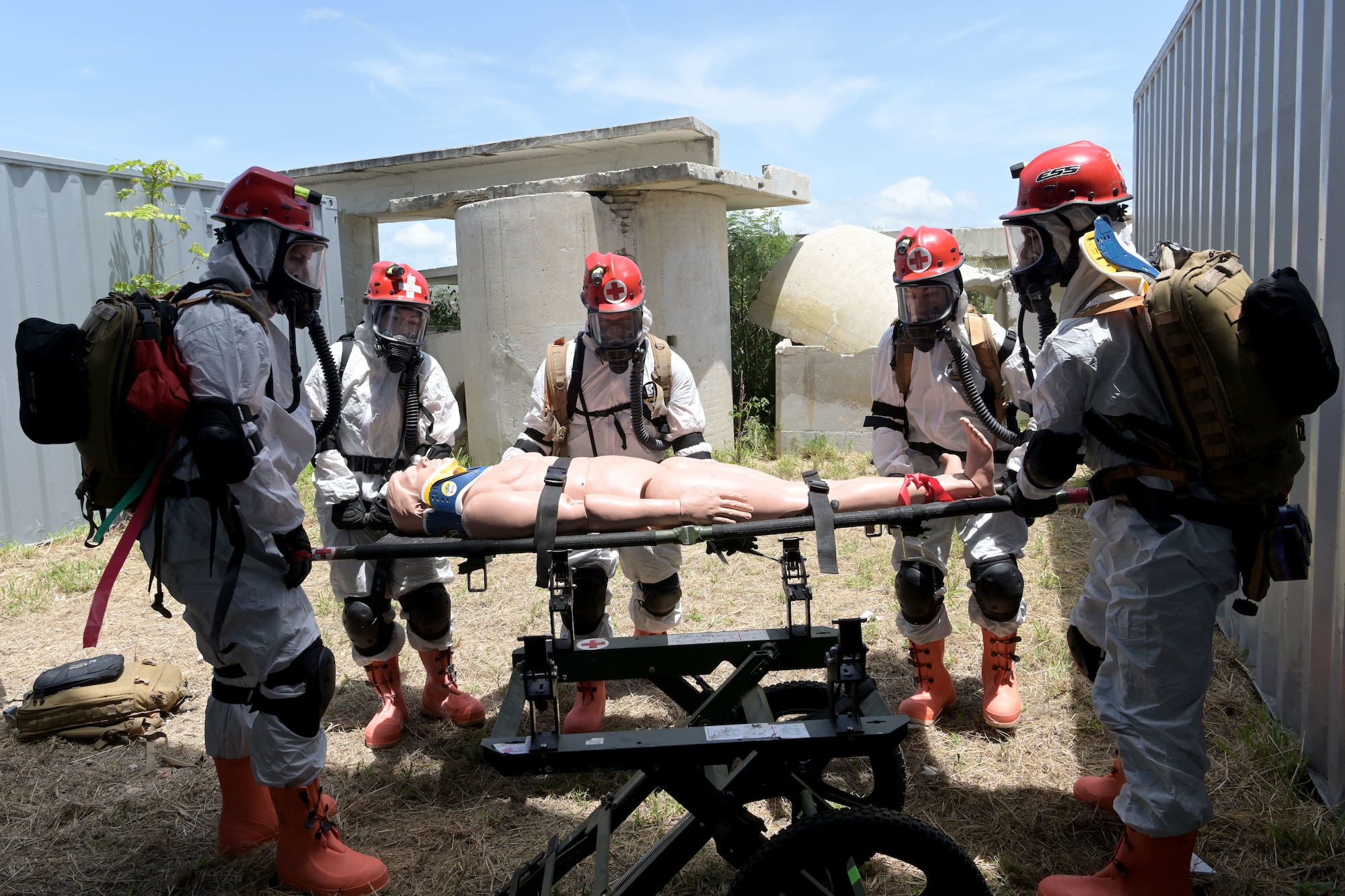 U.S. Airmen with the 156th Medical Group Detachment 1, Chemical, Biological, Radiological, Nuclear and high-yield Explosive Enhanced Response Force Package, assess, stabilize and prepare to transport a simulated victim during a search and extraction training exercise at Camp Santiago Joint Training Center, Salinas, Puerto Rico, Aug. 19, 2021.