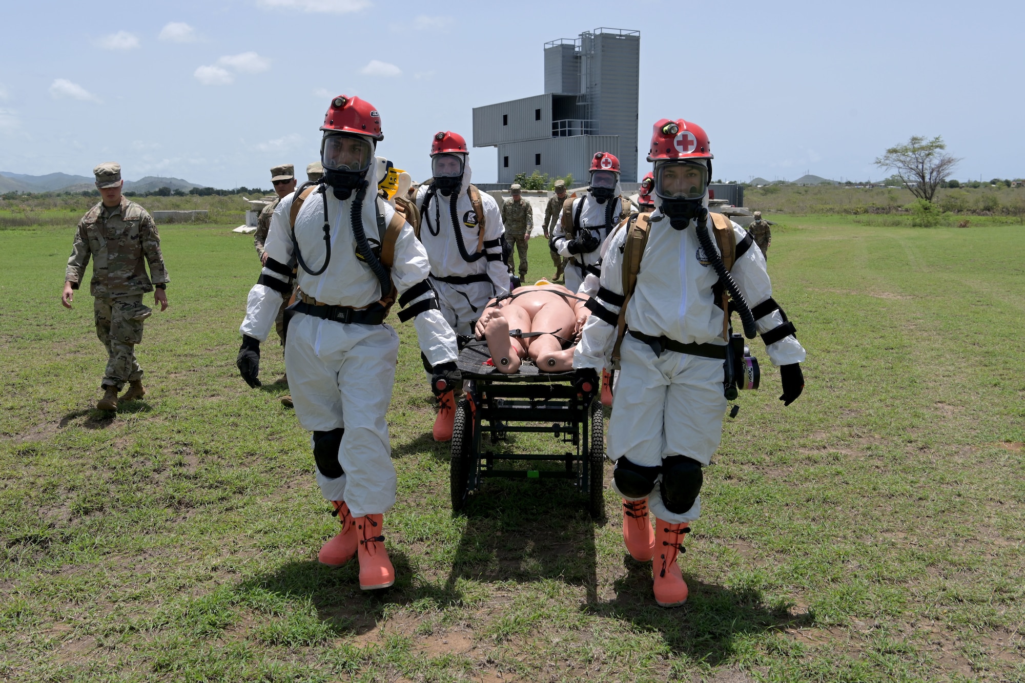 U.S. Airmen with the 156th Medical Group Detachment 1, Chemical, Biological, Radiological, Nuclear and high-yield Explosive Enhanced Response Force Package, transport a simulated victim during a search and extraction training exercise at Camp Santiago Joint Training Center, Salinas, Puerto Rico, Aug. 19, 2021.