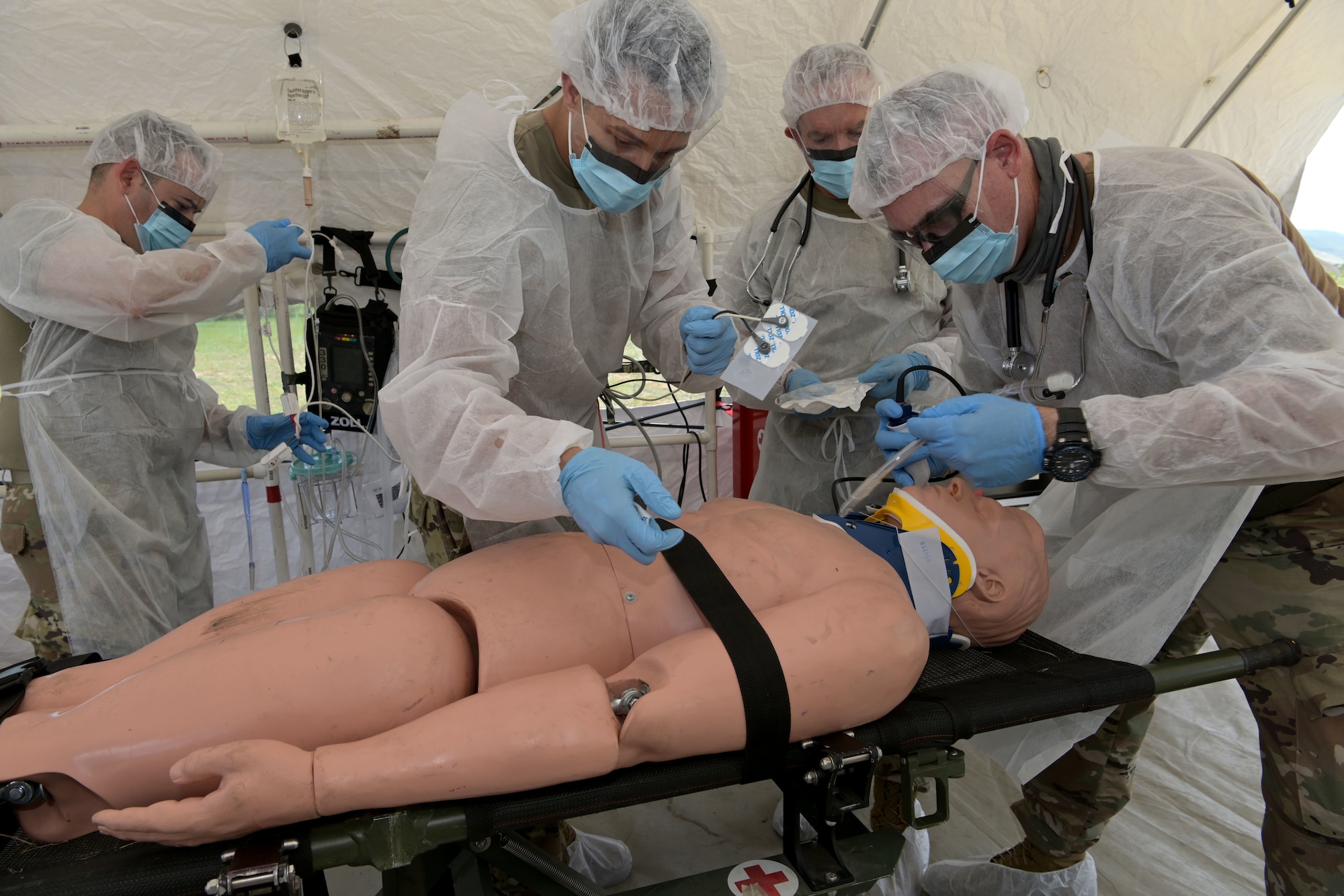 U.S. Air Force medics with the 156th Medical Group Detachment 1, Chemical, Biological, Radiological, Nuclear and high-yield Explosive Enhanced Response Force Package, evaluate and treat a simulated victim during a search and extraction training exercise at Camp Santiago Joint Training Center, Salinas, Puerto Rico, Aug. 19, 2021.