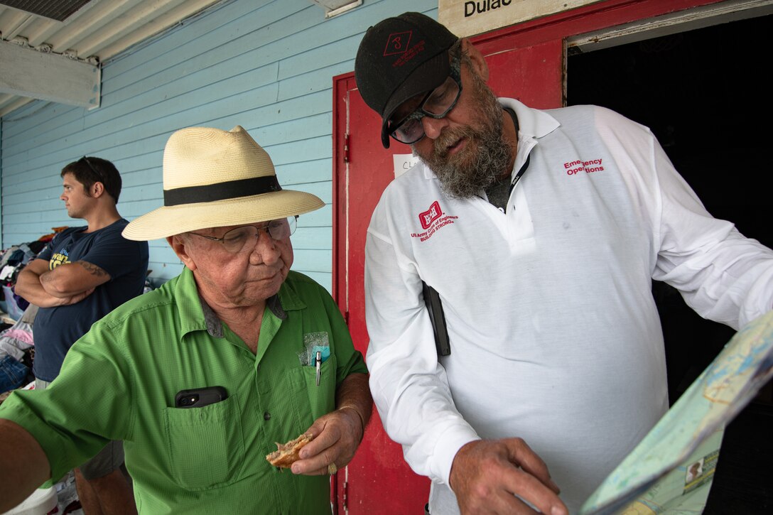James Muilenburg, a US Army Corps of Engineers, Omaha District employee serving as a national local government liaison, looks over a map with Rev. Kirby Verret, a pastor and the Coordinator of Indian Education at Terrebonne Parish School Board as they discuss the highly impacted areas that Muilenburg should visit.