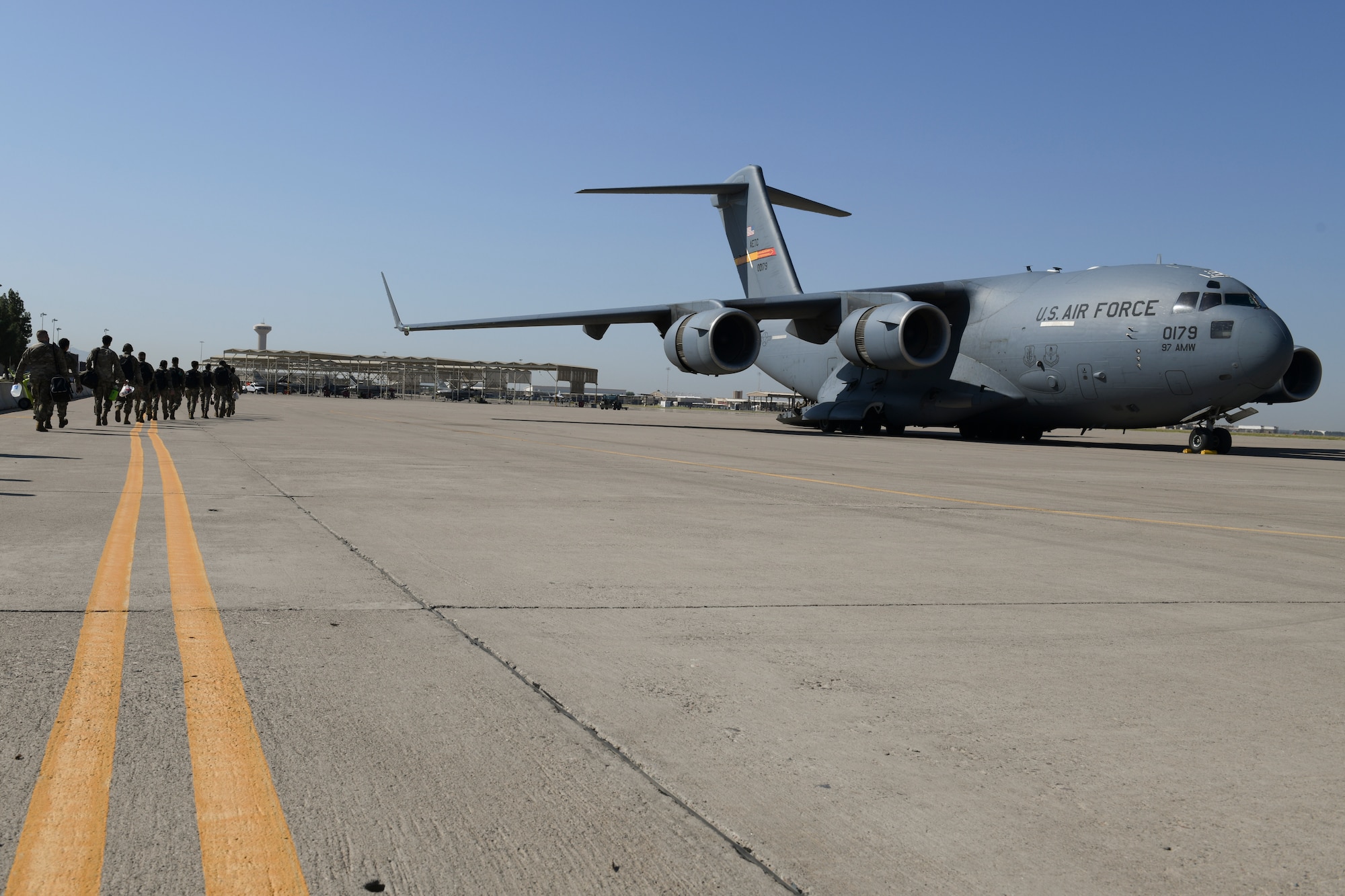 U.S. Airmen from the 56th Fighter Wing walk to a C-17 Globemaster III Sept. 13, 2021, at Luke Air Force Base, Arizona. The C-17 from Altus Air Force Base, Oklahoma, will be transporting Luke Airmen to Joint Base McGuire-Dix-Lakehurst, New Jersey, in support of Operation Allies Welcome, where they will assist with medical screenings, lodging, and other general support services for Afghan evacuees. Luke Airmen rapidly mobilized to answer the call for support with less than a four-day notice to assist with the sheltering of thousands of Afghan evacuees from Kabul, Afghanistan. (U.S. Air Force photo by Tech. Sgt. Amber Carter)
