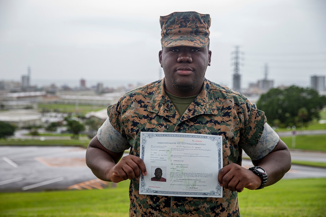 U.S. Marine Corps Lance Cpl. Rhys Stewart, an administrative specialist with the Installation Personnel Administration Center, poses for an environmental portrait with his certificate of naturalization on Camp Foster, Okinawa, Japan, Sept. 13, 2021. Stewart lived in St. Catherine, Jamaica, with his parents for the first 17 years of his life. In 2017, his grandfather, who was already living in the U.S., filed for Stewart and his family to immigrate to Brooklyn, New York. (U.S. Marine Corps photo by Lance Cpl. Alex Fairchild)